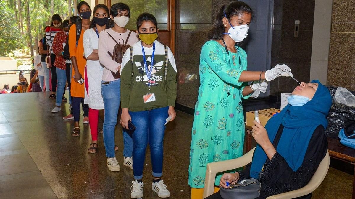 <div class="paragraphs"><p>A medic collects swab sample of students for the COVID-19 test following a surge in coronavirus cases. Representative image. </p></div>