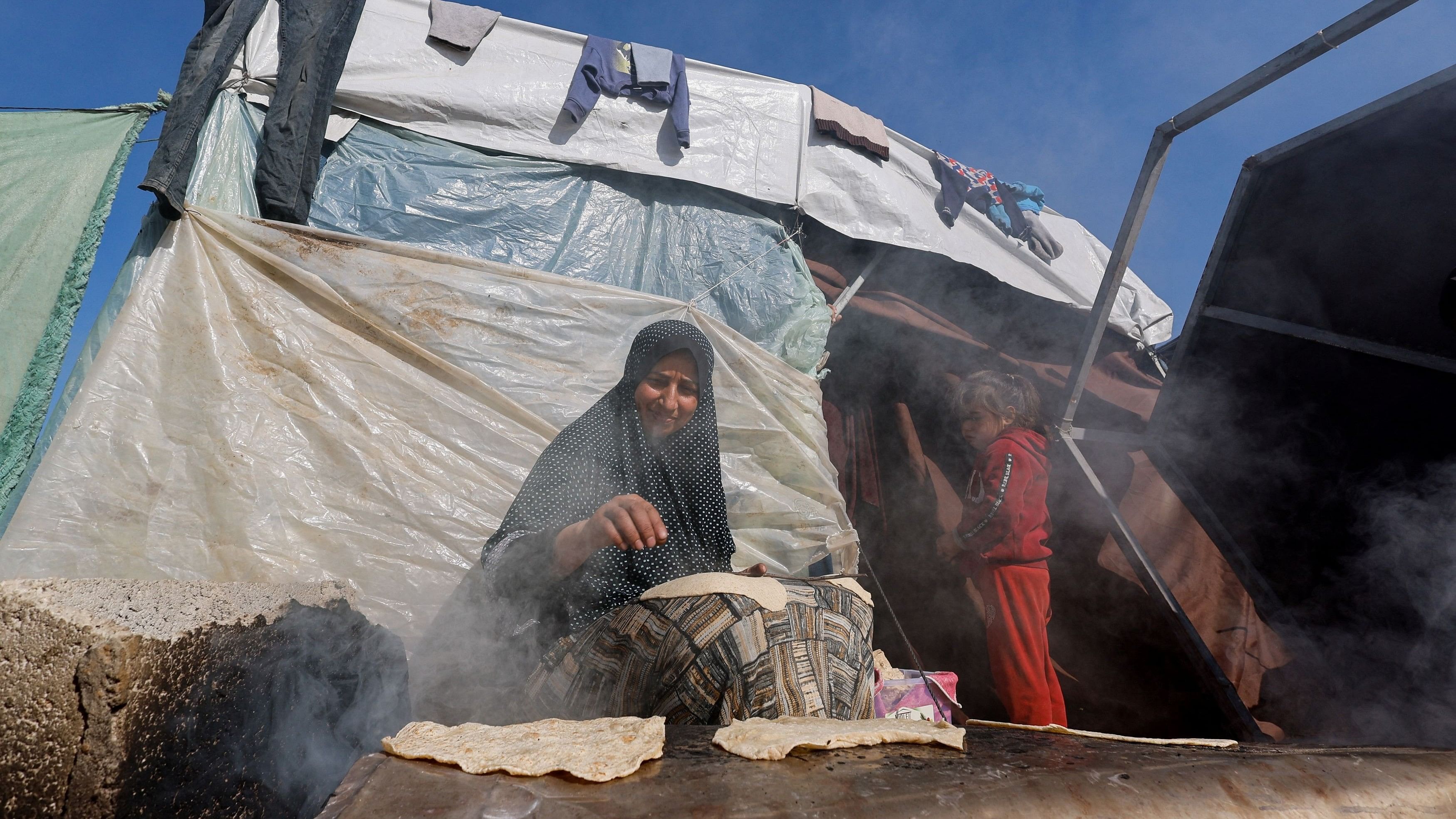 <div class="paragraphs"><p>Displaced Palestinians, who fled their houses due to Israeli strikes, shelter in a tent camp near the border with Egypt, amid the ongoing conflict between Israel and the Palestinian Islamist group Hamas.</p></div>