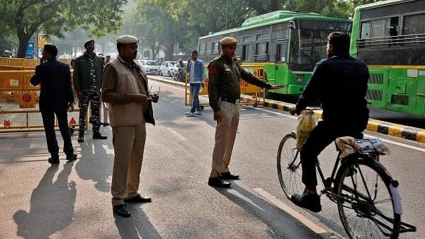 <div class="paragraphs"><p>A police officer stops a cyclist next to a barricade outside the parliament, in New Delhi day after LS breach.</p></div>