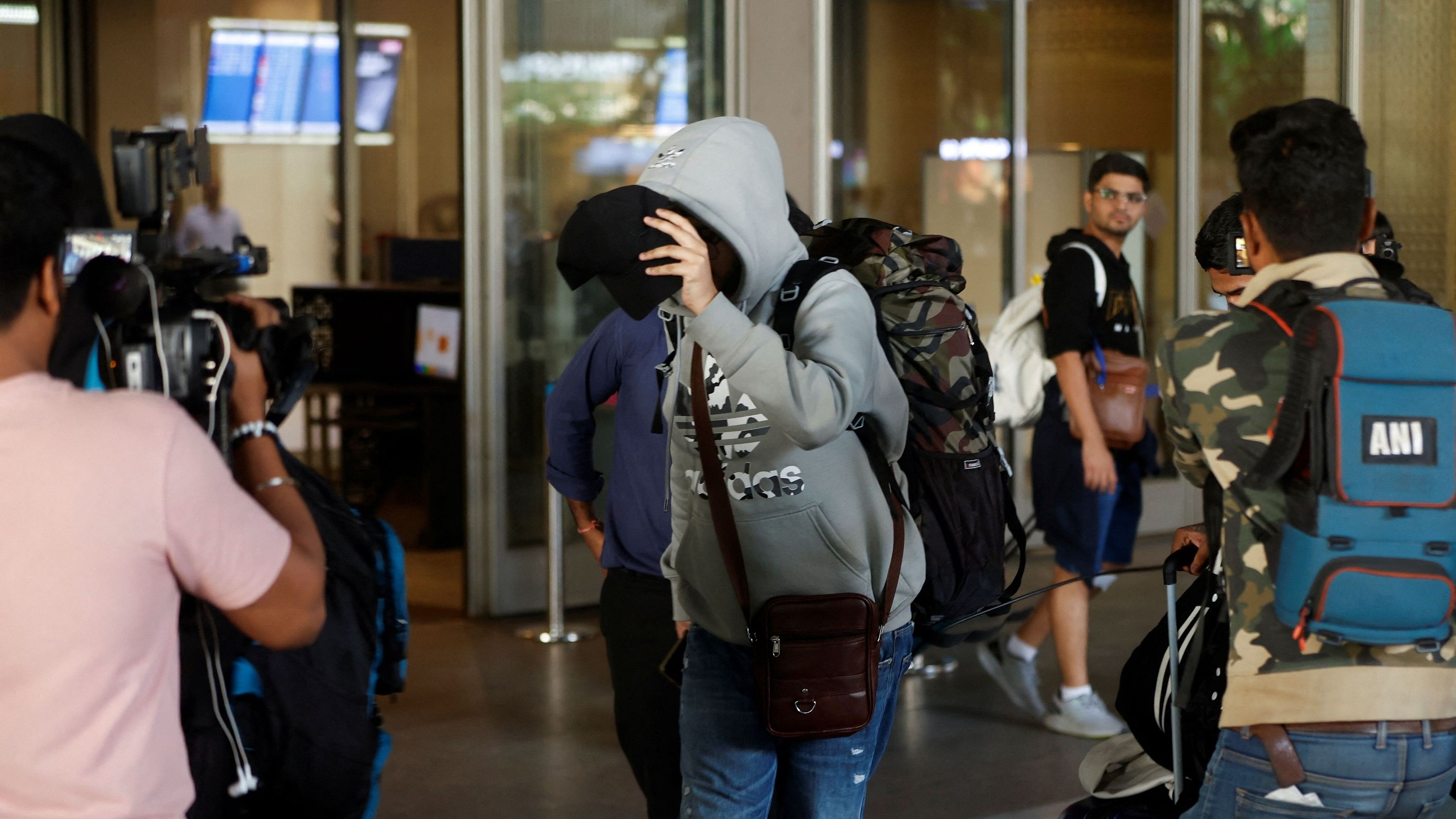 <div class="paragraphs"><p>A passenger from Nicaragua bound Airbus A340 flight that was grounded in France on suspicion of human trafficking, evades the media as he leaves the Chhatrapati Shivaji Maharaj International Airport after his arrival, in Mumbai, India, December 26, 2023.<br></p></div>