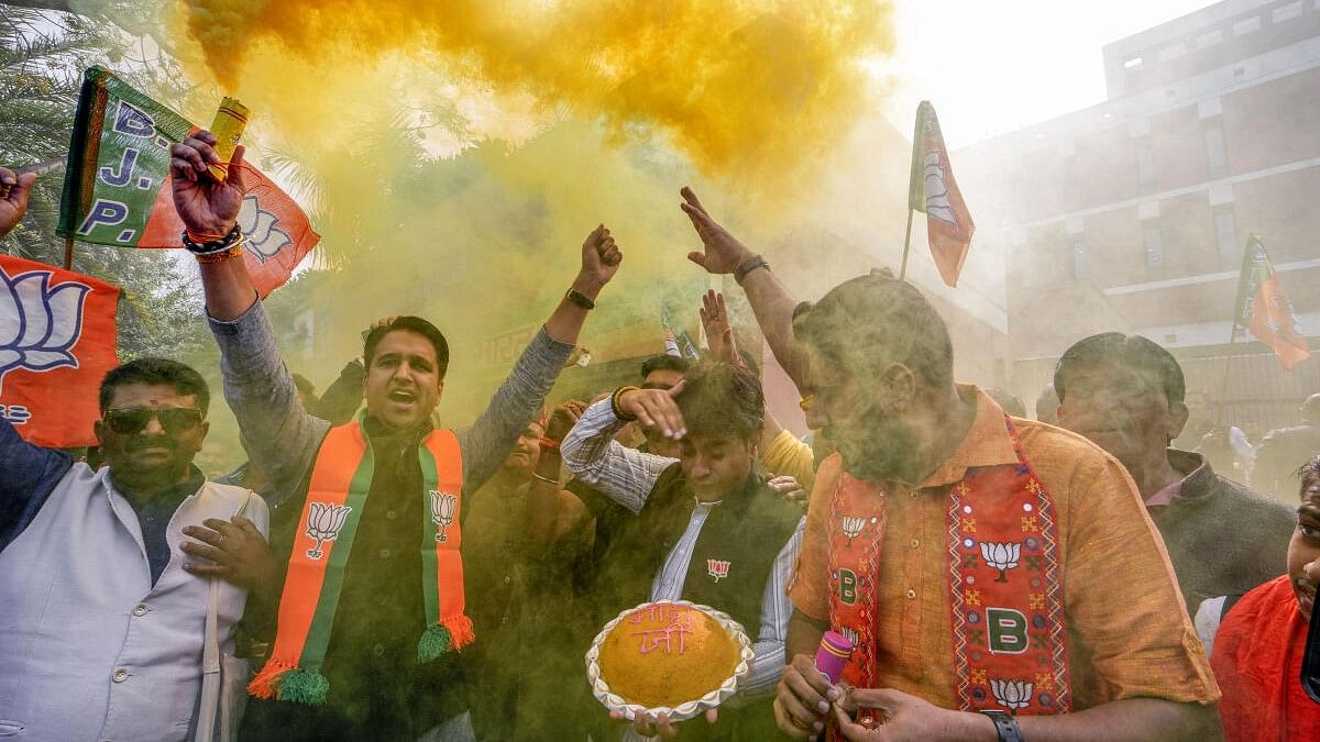 <div class="paragraphs"><p>BJP workers and supporters celebrate the party's lead in Madhya Pradesh, Rajasthan and Chhattisgarh during counting of votes, at the party headquarters, in New Delhi.</p></div>