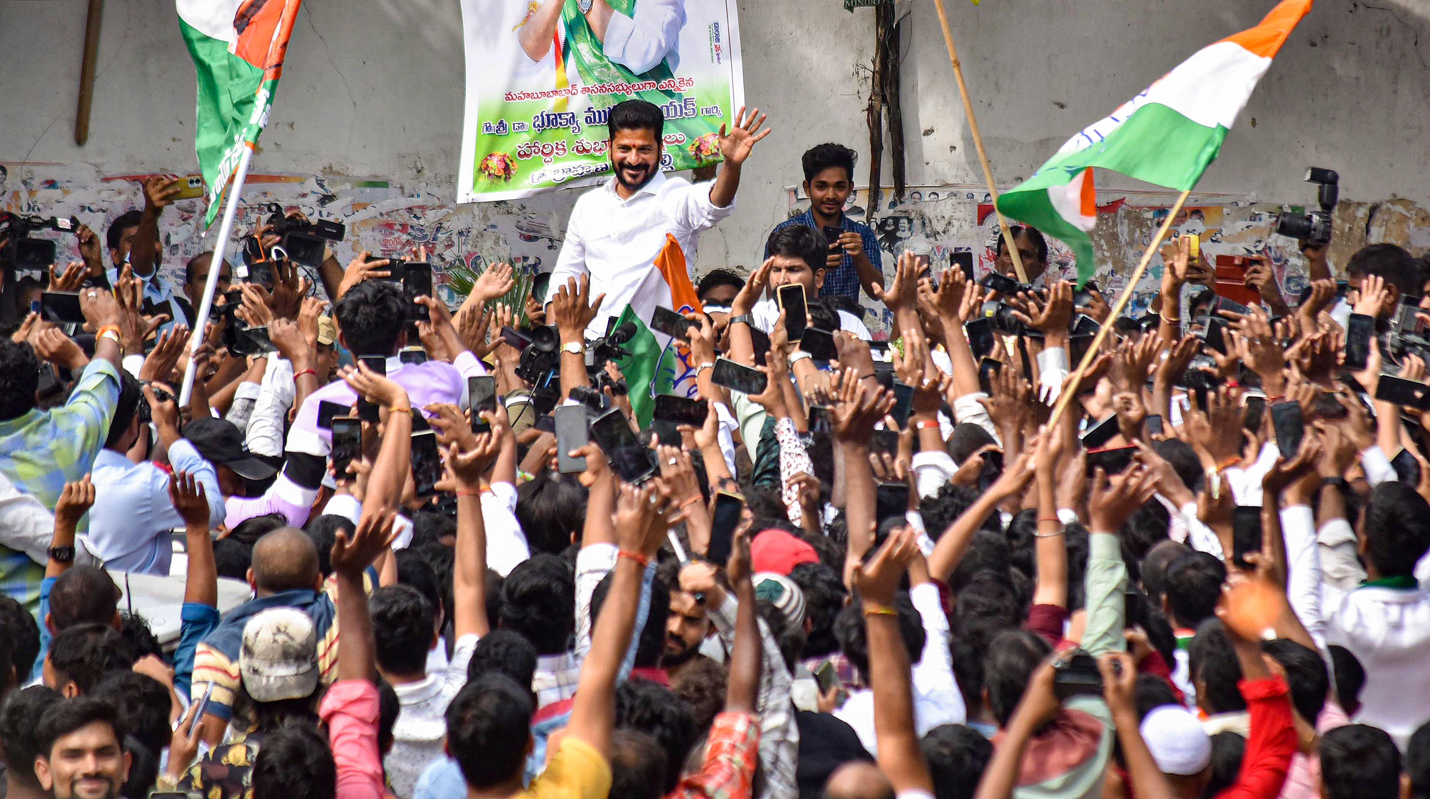 <div class="paragraphs"><p>Congress Telangana President A Revanth Reddy greets party workers and supporters celebrating the party's lead during the counting of votes for Telangana Assembly elections, in Hyderabad, Sunday, Dec. 3, 2023. </p></div>