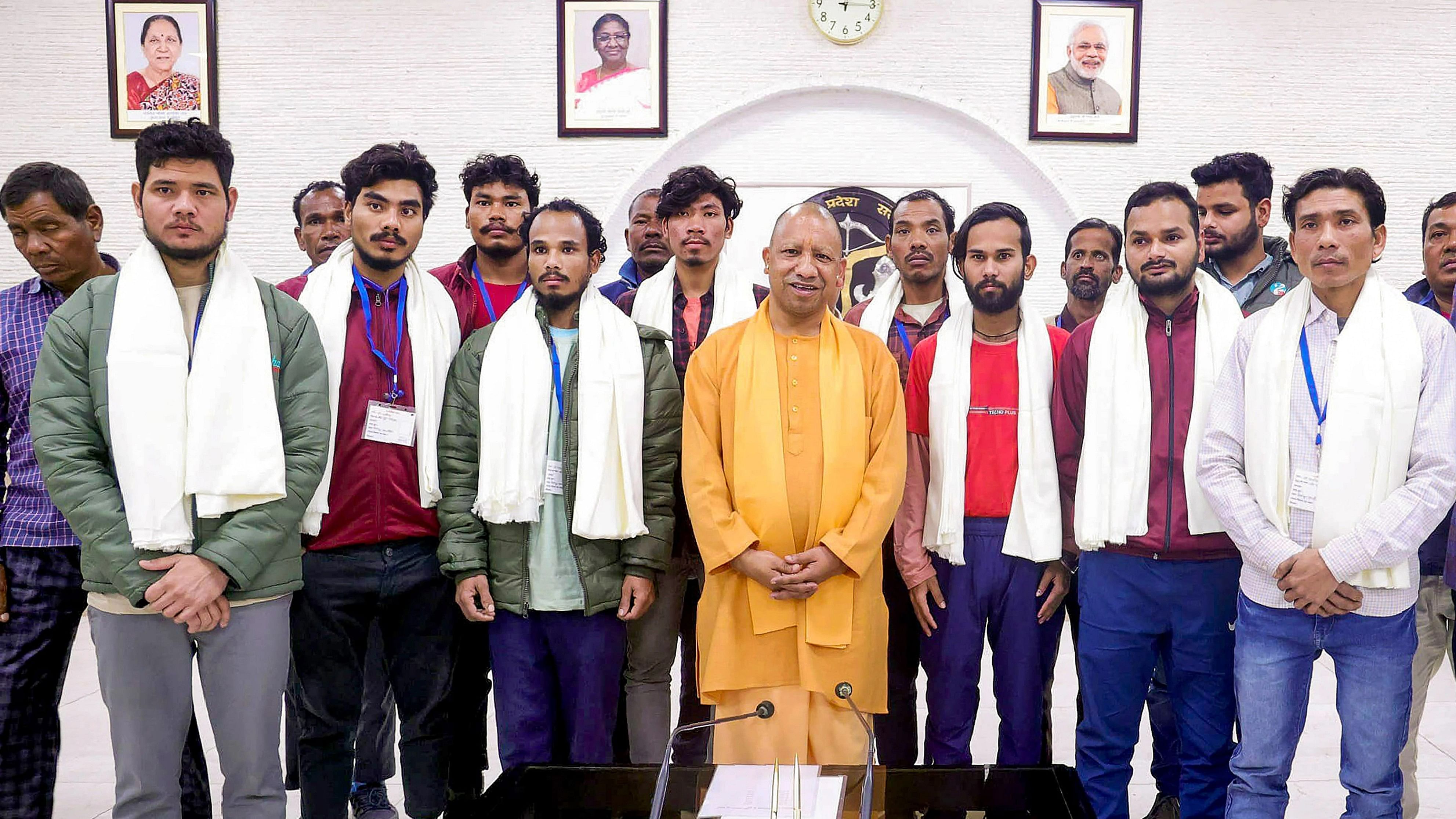 <div class="paragraphs"><p> Uttar Pradesh Chief Minister Yogi Adityanath poses for photos with the rescued workers of Uttarakhands Silkyara Tunnel, at his official residence in Lucknow, Friday, Dec. 1, 2023. </p></div>
