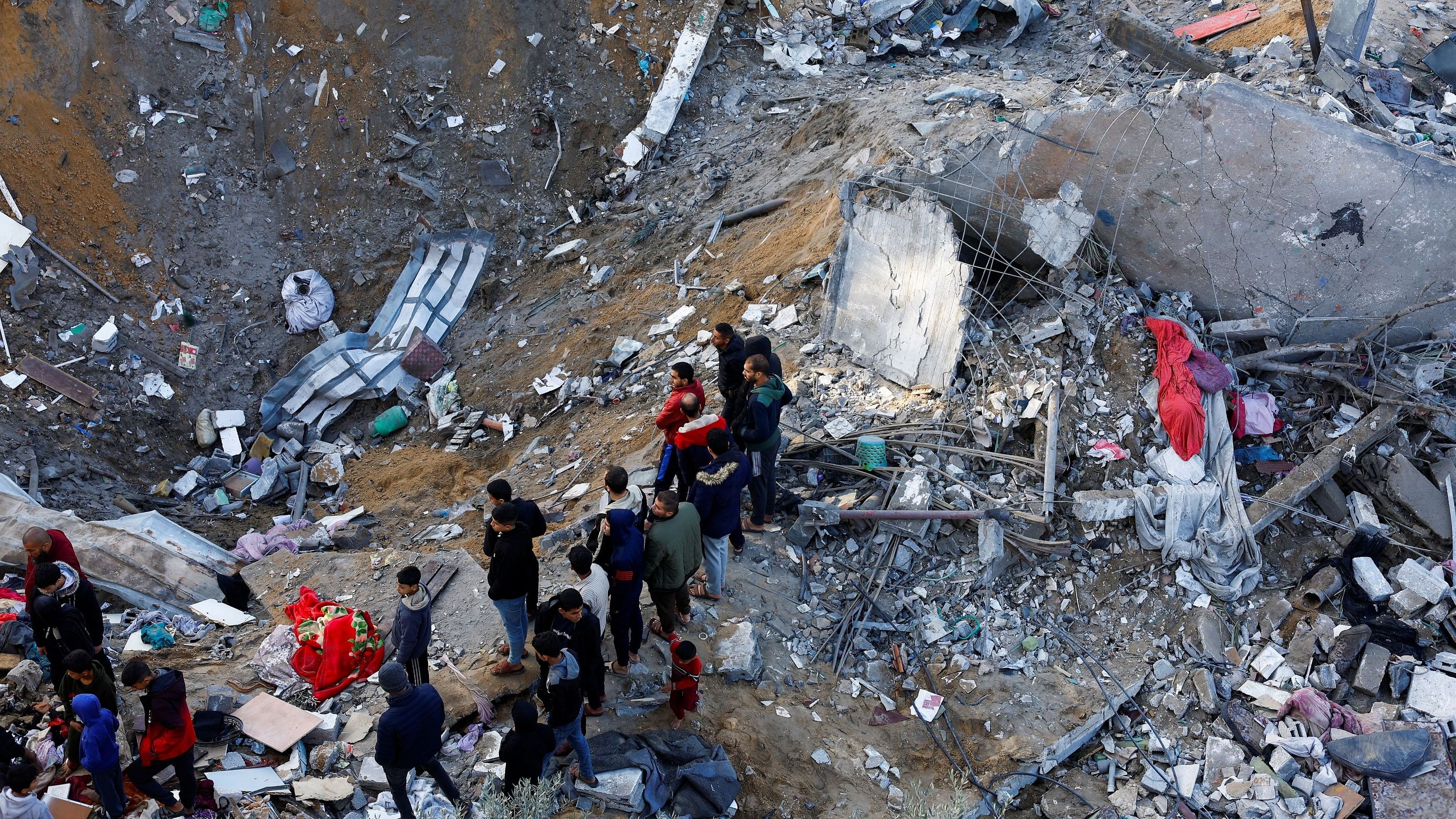 <div class="paragraphs"><p>Palestinians gather to search for casualties at the site of Israeli strikes on houses amid the ongoing conflict between Israel and the Palestinian Islamist group Hamas, in Rafah in the southern Gaza Strip.</p></div>