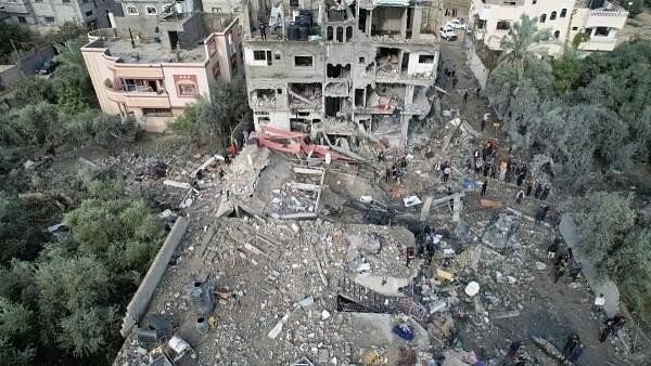 <div class="paragraphs"><p>Palestinians gather at the site of Israeli strikes on houses, amid the ongoing conflict between Israel and the Palestinian Islamist group Hamas, at the Maghazi camp in the central Gaza Strip.</p></div>