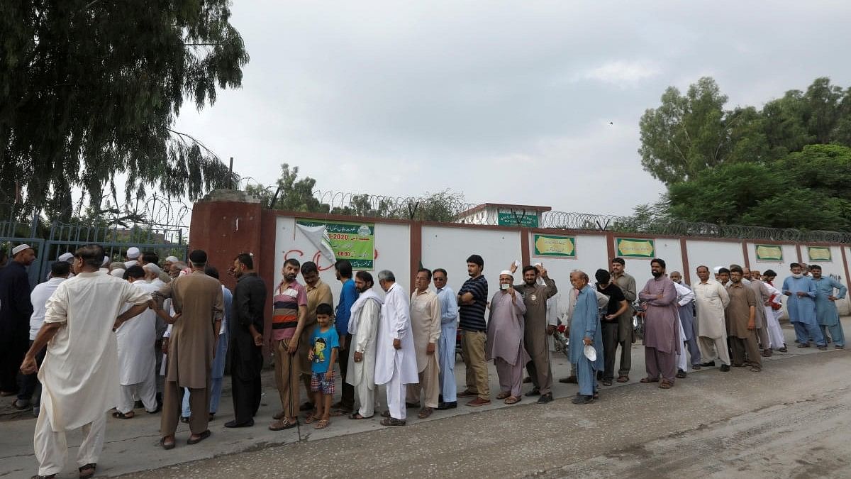 <div class="paragraphs"><p>People stand in a line as they wait for a polling station to open, during general election in Rawalpindi, Pakistan July 25, 2018. </p></div>