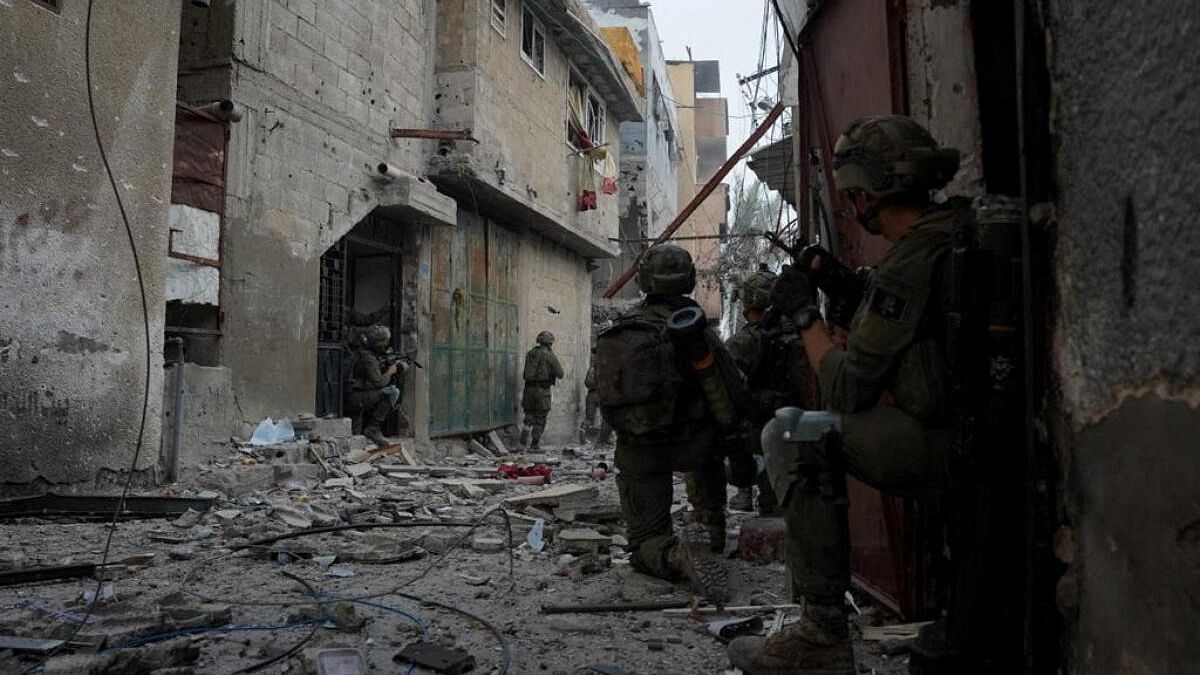 <div class="paragraphs"><p>Israeli soldiers take positions during urban combat, at a location given as Khan Younis, Gaza Strip, during their ground operation against Palestinian Islamist group Hamas, in this handout image released December 24, 2023.</p></div>