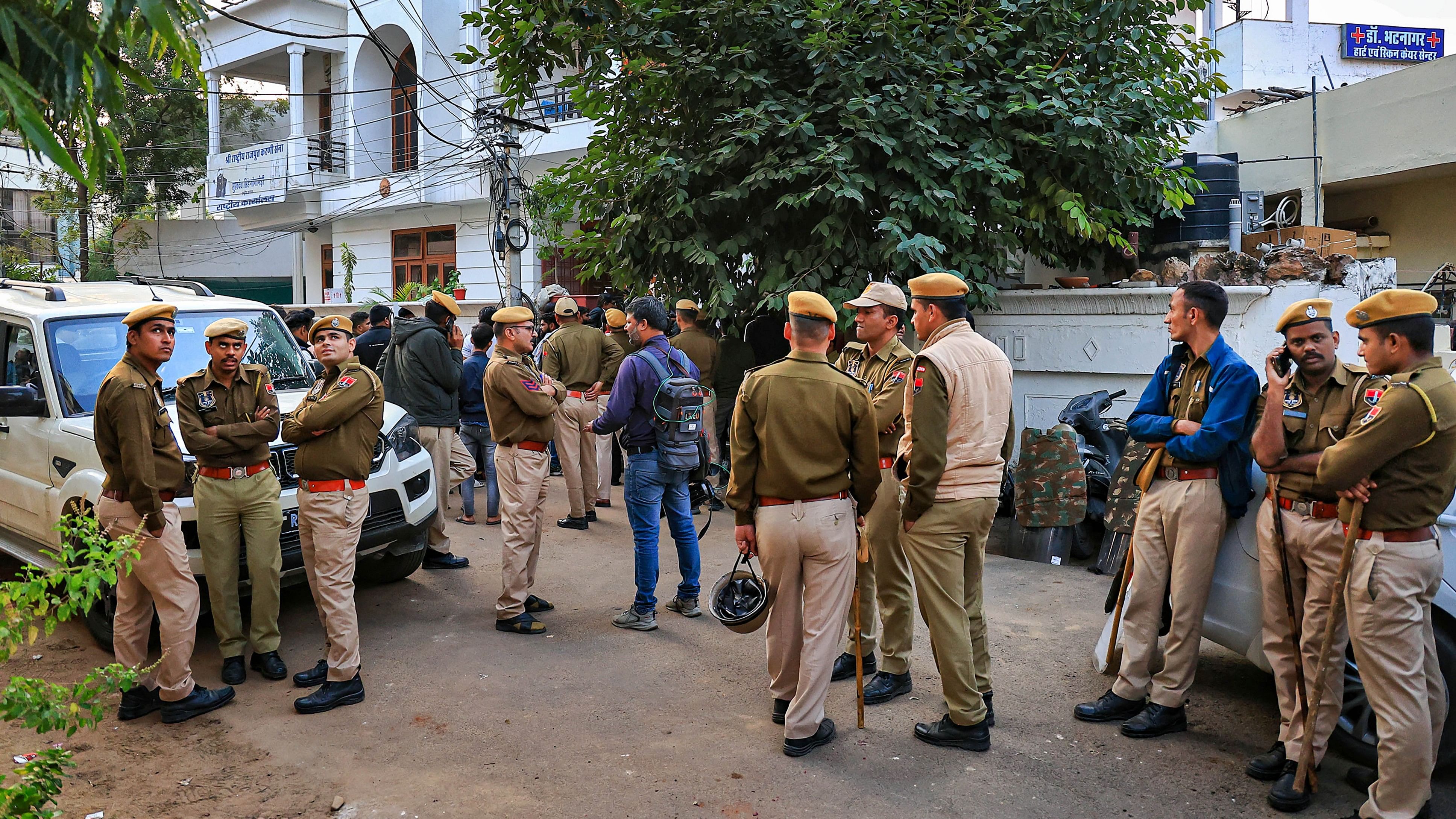 <div class="paragraphs"><p>Police personnel and FSL team members outside the residence of Shri Rashtriya Rajput Karni Sena's President Sukhdev Singh Gogamedi, where he was shot dead by unidentified assailants, in Jaipur, Tuesday.</p></div>