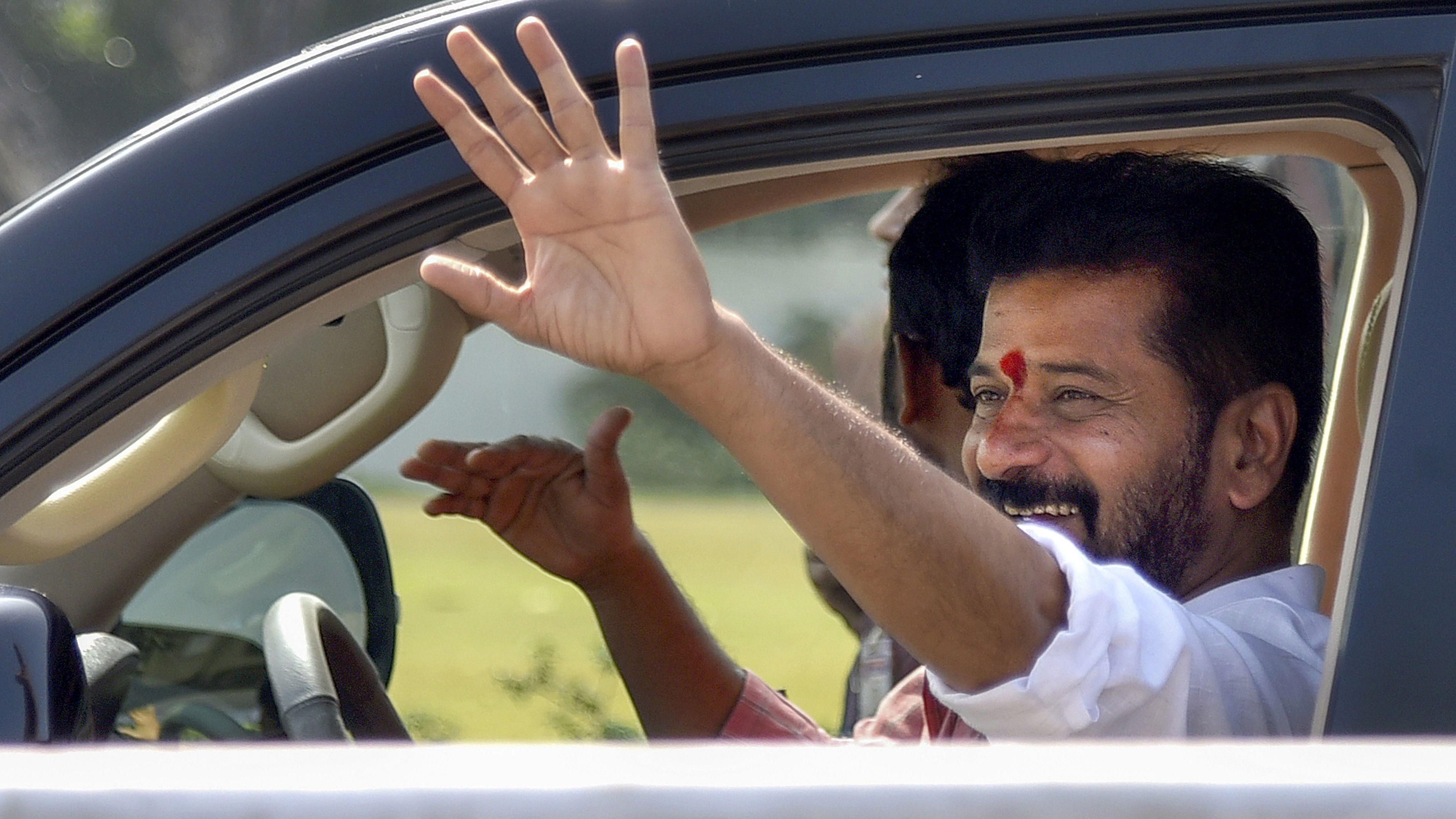 <div class="paragraphs"><p>Telangana Chief Minister A Revanth Reddy waves from his car during 'Praja Darbar', at Praja Bhavan in Hyderabad, Friday, Dec. 8, 2023. </p></div>