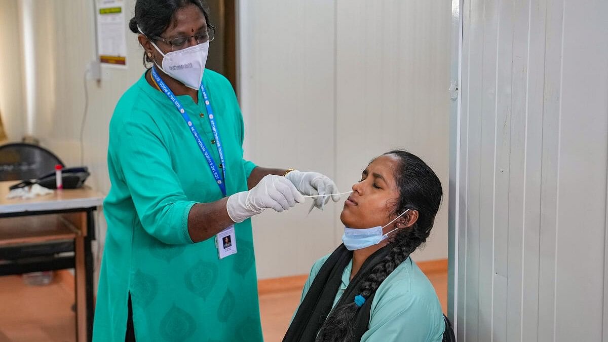 <div class="paragraphs"><p>A healthcare worker conducts a covid-19 test of a woman amid detection of the&nbsp;JN.1 variant of coronavirus in India.&nbsp;</p></div>