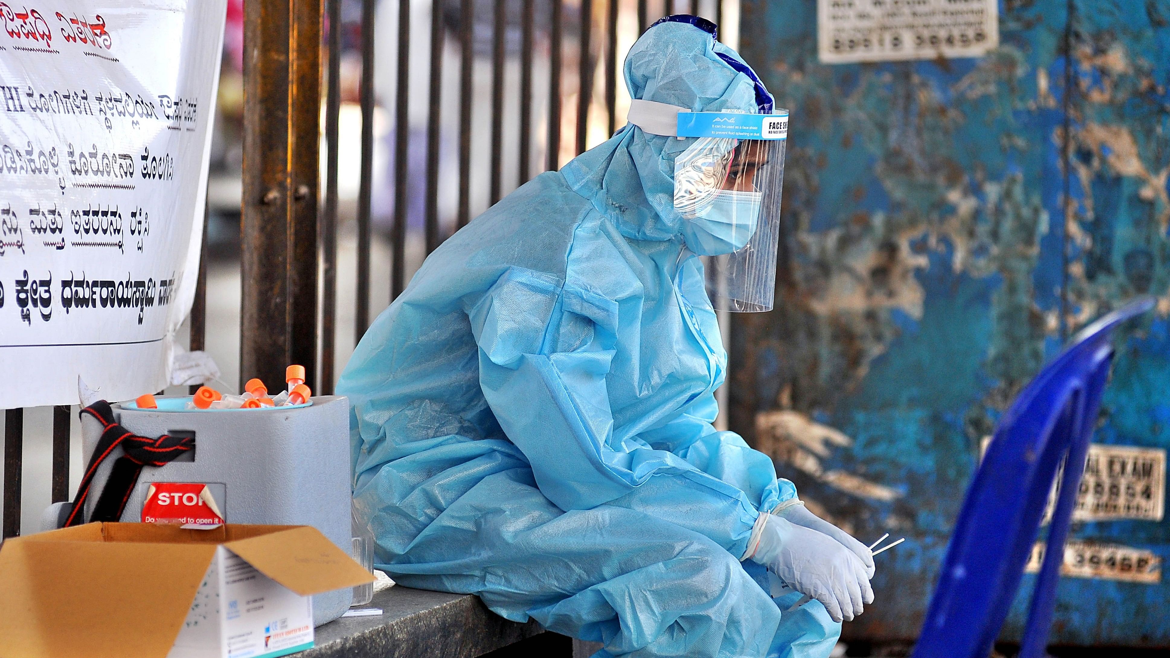 <div class="paragraphs"><p>A medical staff takes a break from collecting Covid-19 test samples. </p></div>