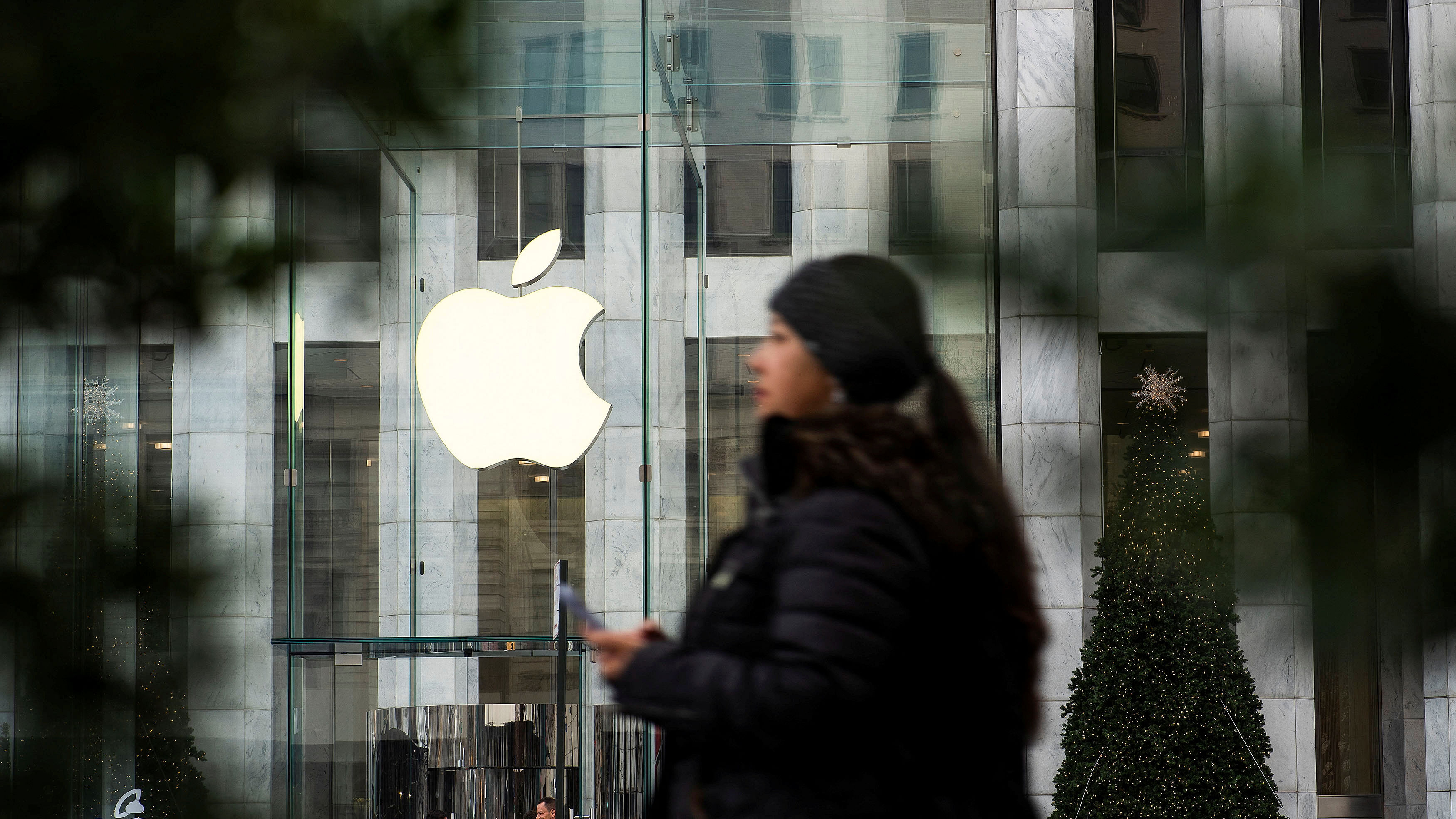 <div class="paragraphs"><p>File Photo: A woman walks near the Apple store.</p></div>