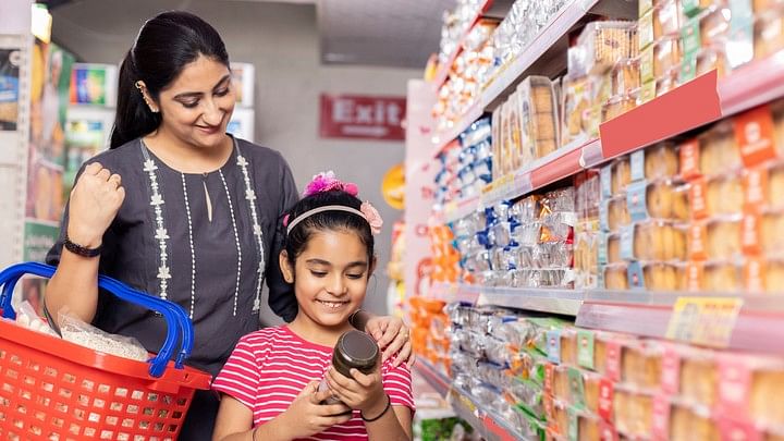 <div class="paragraphs"><p>Representative image showing a mother and daughter check out a label on a jar in a store.</p></div>