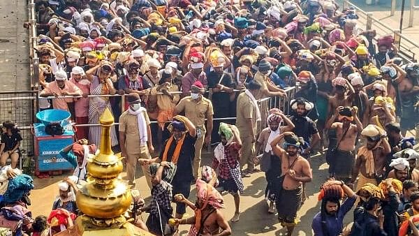 <div class="paragraphs"><p>Ayyappa devotees wait to offer prayers at Sabarimala temple, in Pathanamthitta, earlier this month.</p></div>