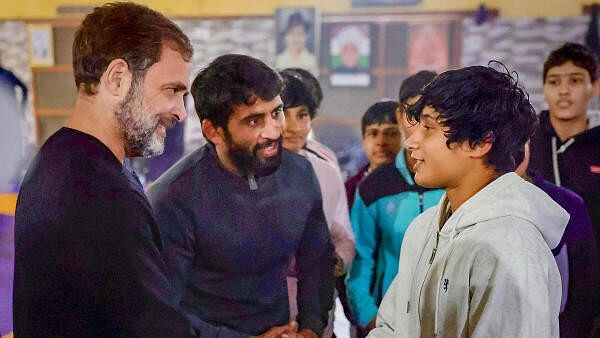 <div class="paragraphs"><p>Congress leader Rahul Gandhi with wrestler Bajrang Punia and other wrestlers at Chhara village, in Jhajjar district.</p></div>
