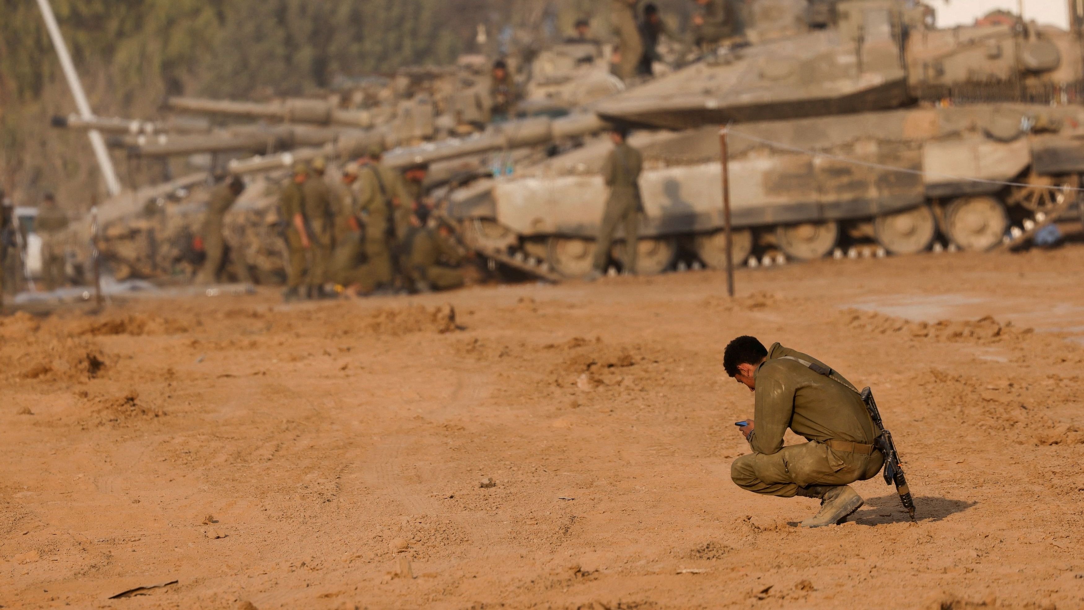 <div class="paragraphs"><p>An Israeli soldier looks at his phone, after returning from the Israeli military's ongoing ground operation in Gaza, amid the conflict between Israel and the Palestinian Islamist group Hamas, near the Israel-Gaza border, in Israel, December 30, 2023. </p></div>