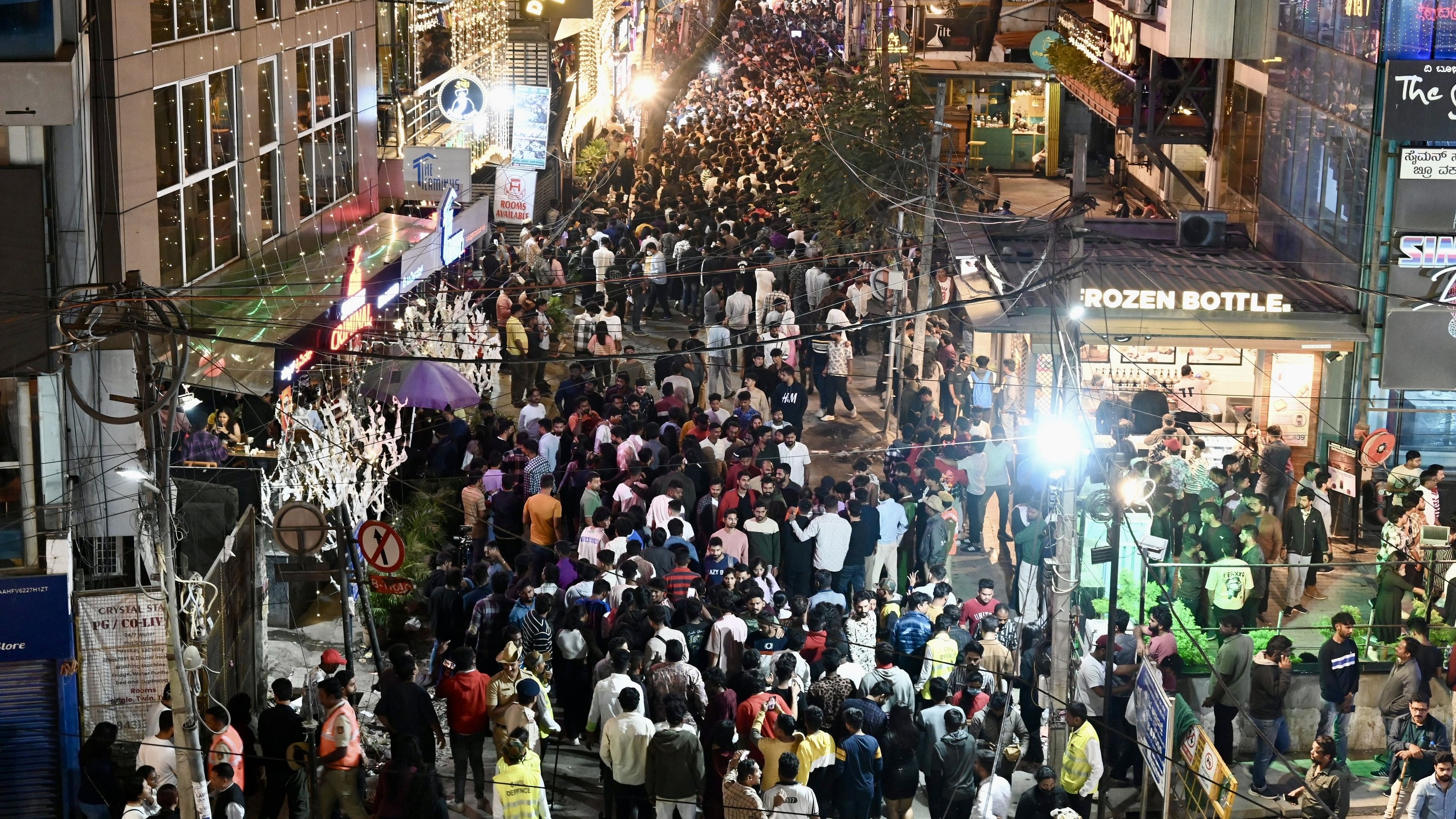 <div class="paragraphs"><p>Party goers throng Koramangala on New Year’s Eve in Bengaluru on Sunday. </p></div>