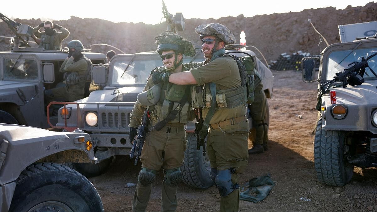 <div class="paragraphs"><p>Israeli soldiers prepare to enter Gaza, amid the ongoing conflict between Israel and the Palestinian Islamist group Hamas, on the Israeli side of the Israel-Gaza border, December 11, 2023.</p></div>