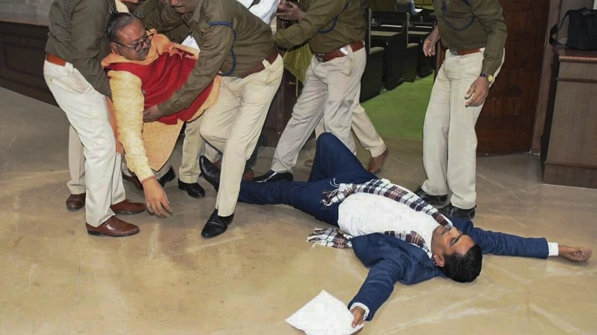 <div class="paragraphs"><p>Jharkhand BJP MLAs Bhanu Pratap Sahi and Biranchi Narayan being removed by Assembly Marshals after their protest inside the assembly, in Ranchi, Tuesday, Dec. 19, 2023.</p></div>