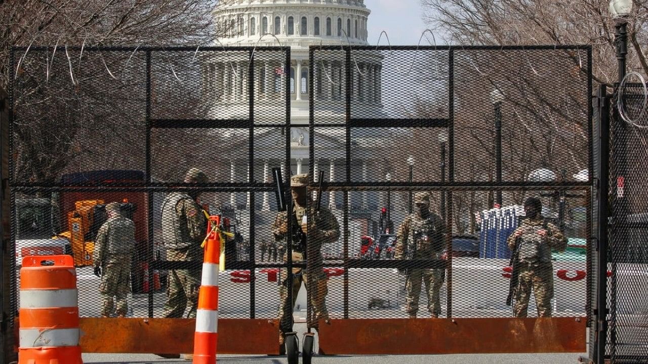 <div class="paragraphs"><p>National Guard soldiers stand guard behind a security fence near the US Capitol. </p></div>