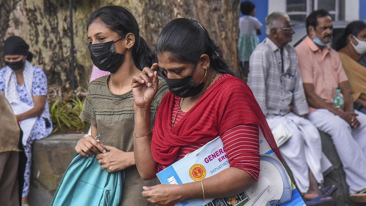 <div class="paragraphs"><p>Visitors wear masks at the Ernakulam Government Hospital after rise in number of COVID cases, in Kochi.</p></div>