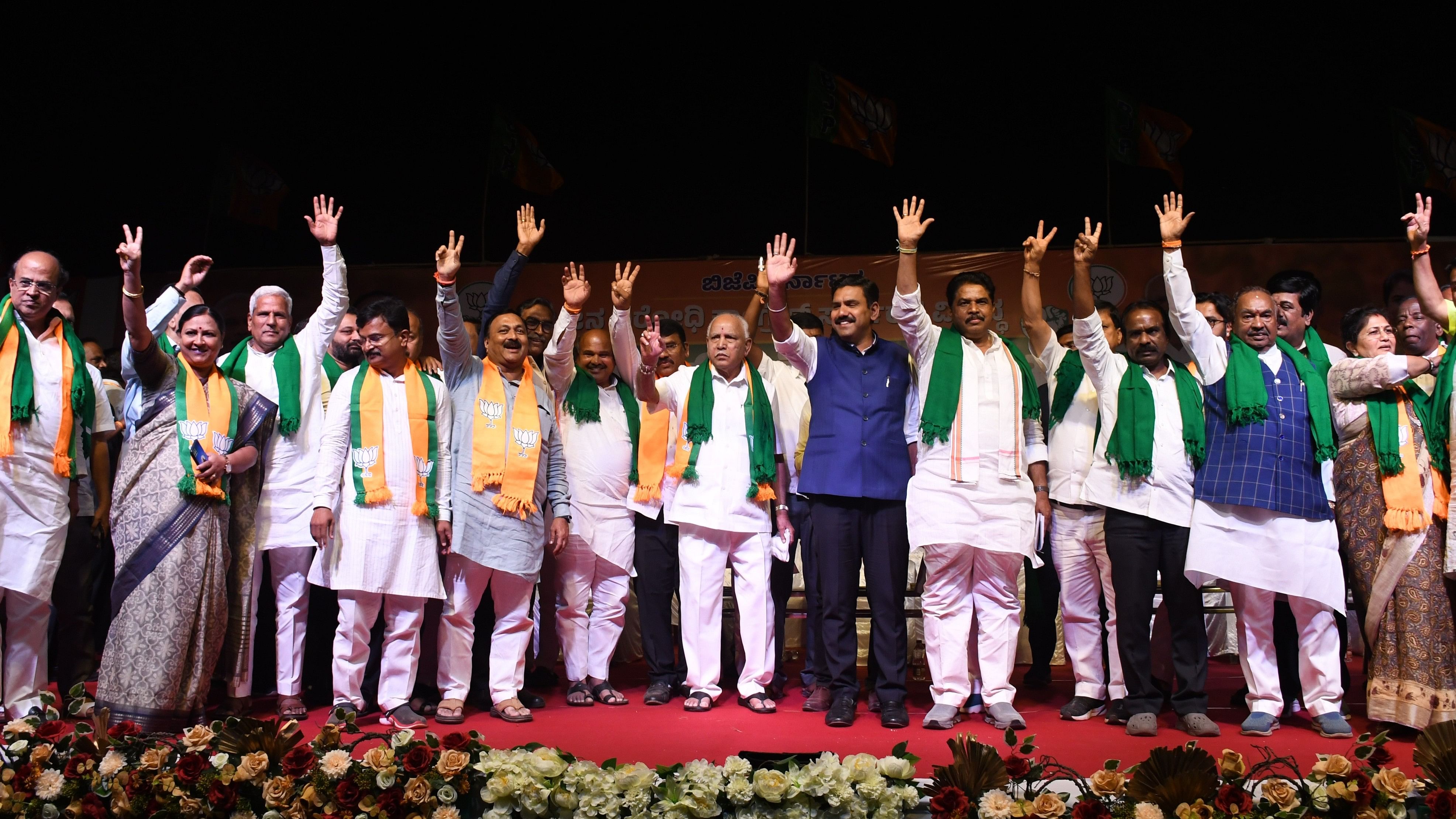 BJP leaders B S Yediyurappa, B Y Vijayendra, R Ashoka, K S Eshwarappa and others wave at the people during a massive protest rally organised against the state government in Belagavi on Wednesday. DH Photo