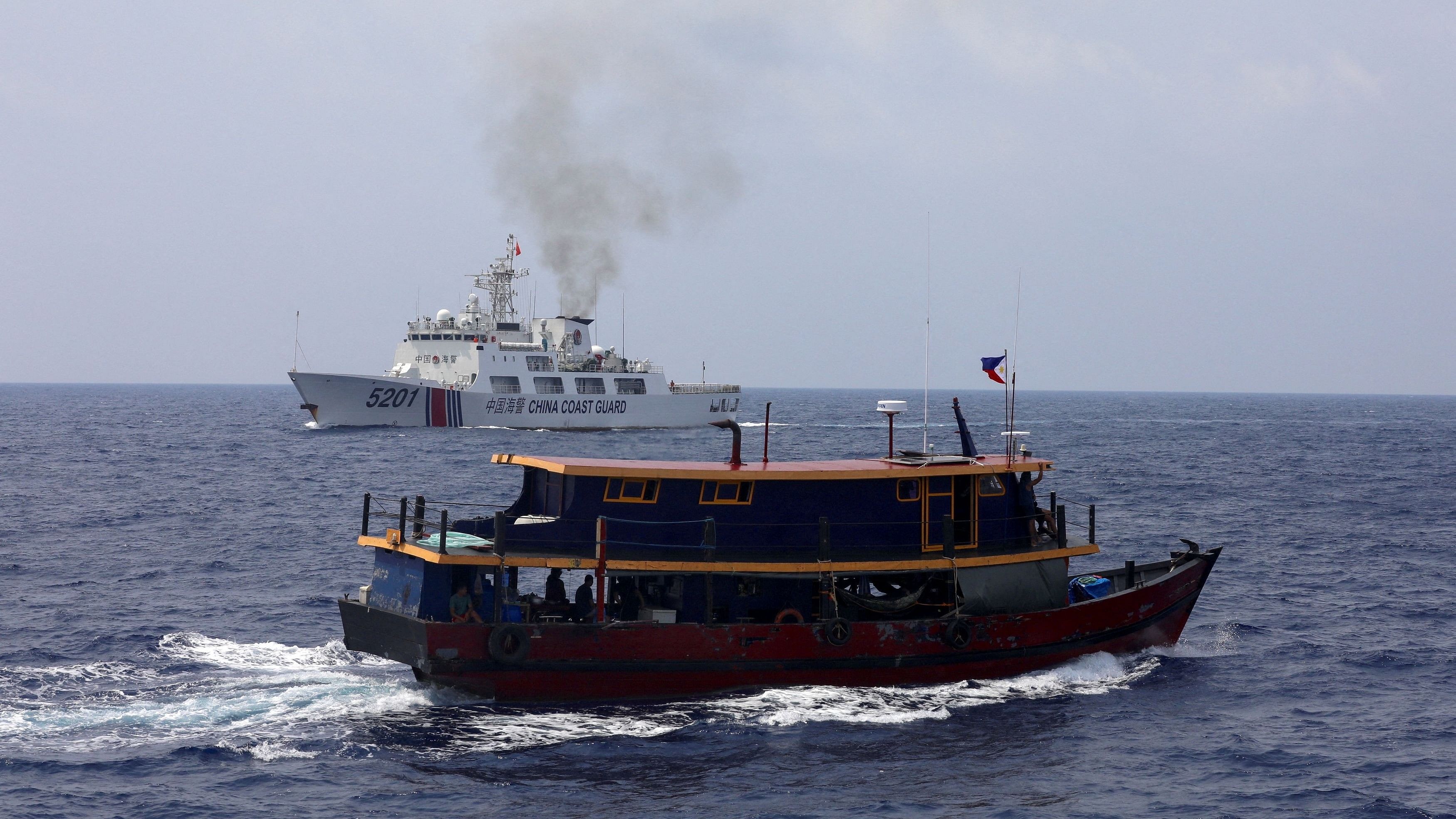 <div class="paragraphs"><p>A Philippine supply boat sails near a Chinese Coast Guard ship in the South China Sea.</p></div>