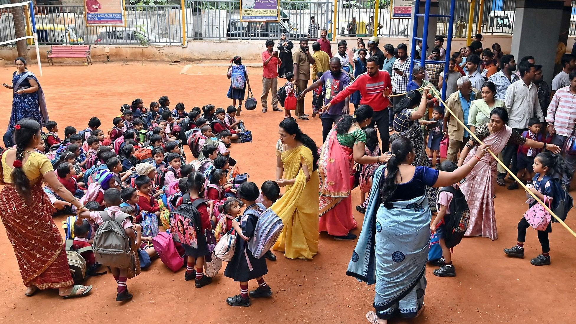 <div class="paragraphs"><p>Teachers of Bhavan-Bangalore Press School escort students to the ground while police inspect the premises.  </p></div>