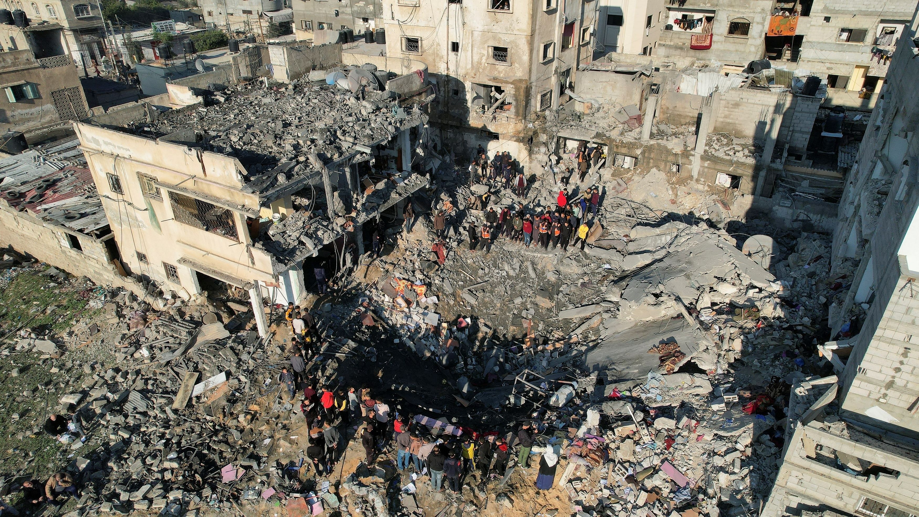<div class="paragraphs"><p>Palestinians gather at the site of an Israeli strike on a house, as the conflict between Israel and the Palestinian Islamist group Hamas continues, in Rafah in the southern Gaza Strip.</p></div>