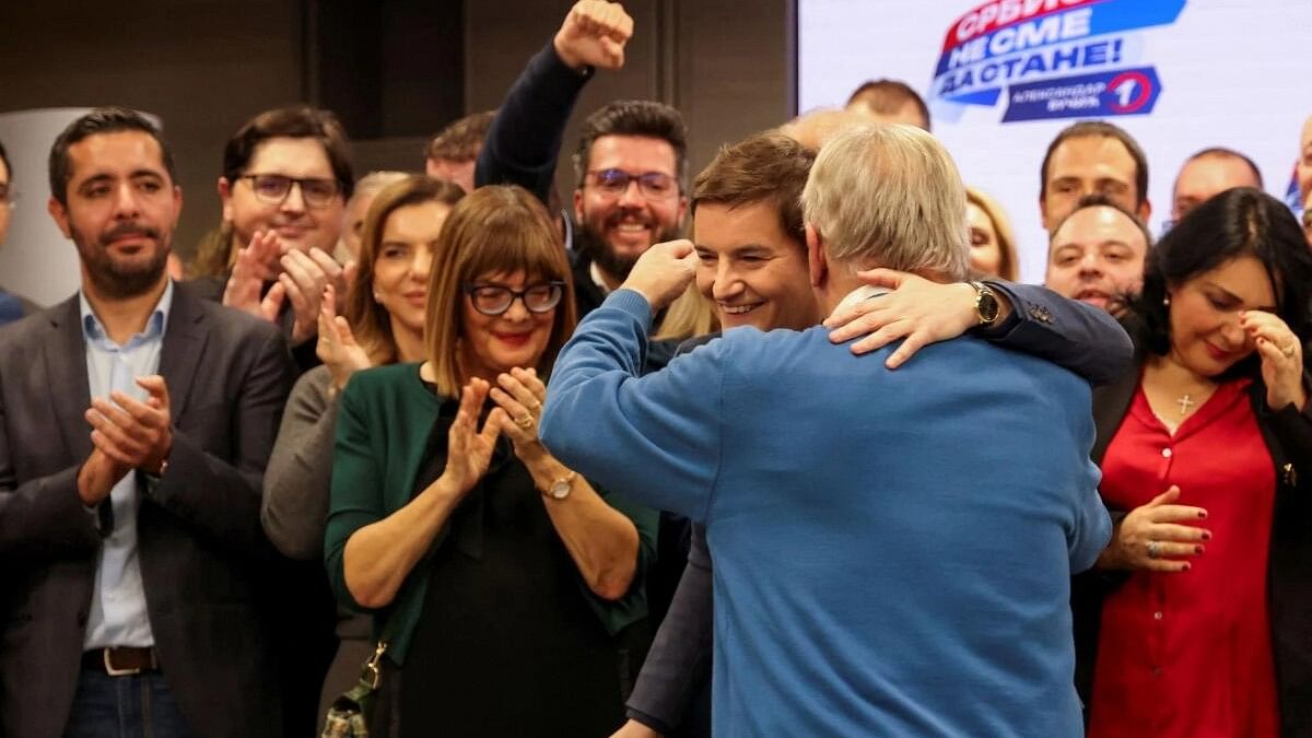 <div class="paragraphs"><p>Serbian Prime Minister Ana Brnabic embraces a person at Serbian Progressive Party (SNS) headquarters, following exit polls results of the parliamentary election in Belgrade.</p></div>