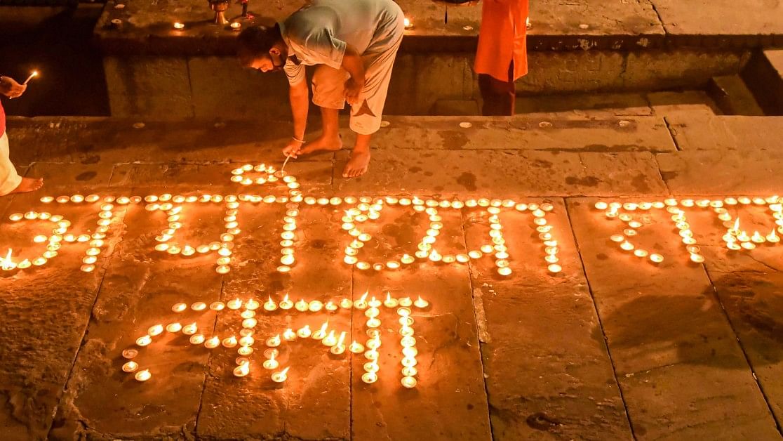 <div class="paragraphs"><p>Devotees light earthern lamps during Ganga 'aarti' at Dashashmedh Ghat, ahead of the foundation laying ceremony of Ram Temple in Ayodhya, in Varanasi. </p></div>