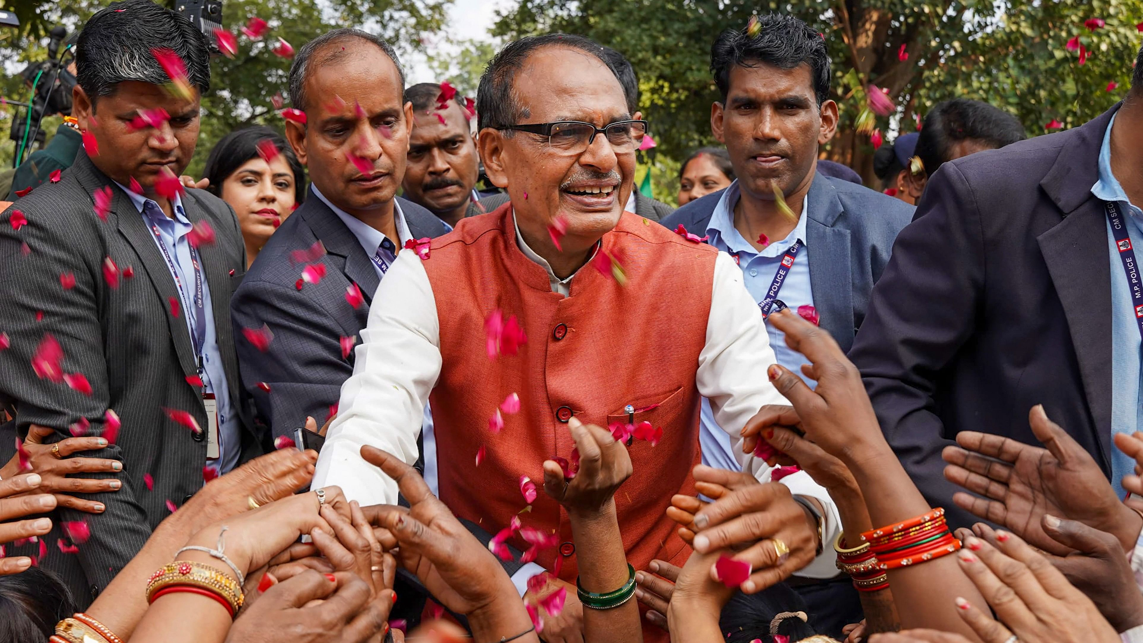 <div class="paragraphs"><p>Madhya Pradesh Chief Minister Shivraj Singh Chouhan with BJP workers and supporters celebrates the party's lead during counting of votes for MP Assembly elections, in Bhopal.<br></p></div>