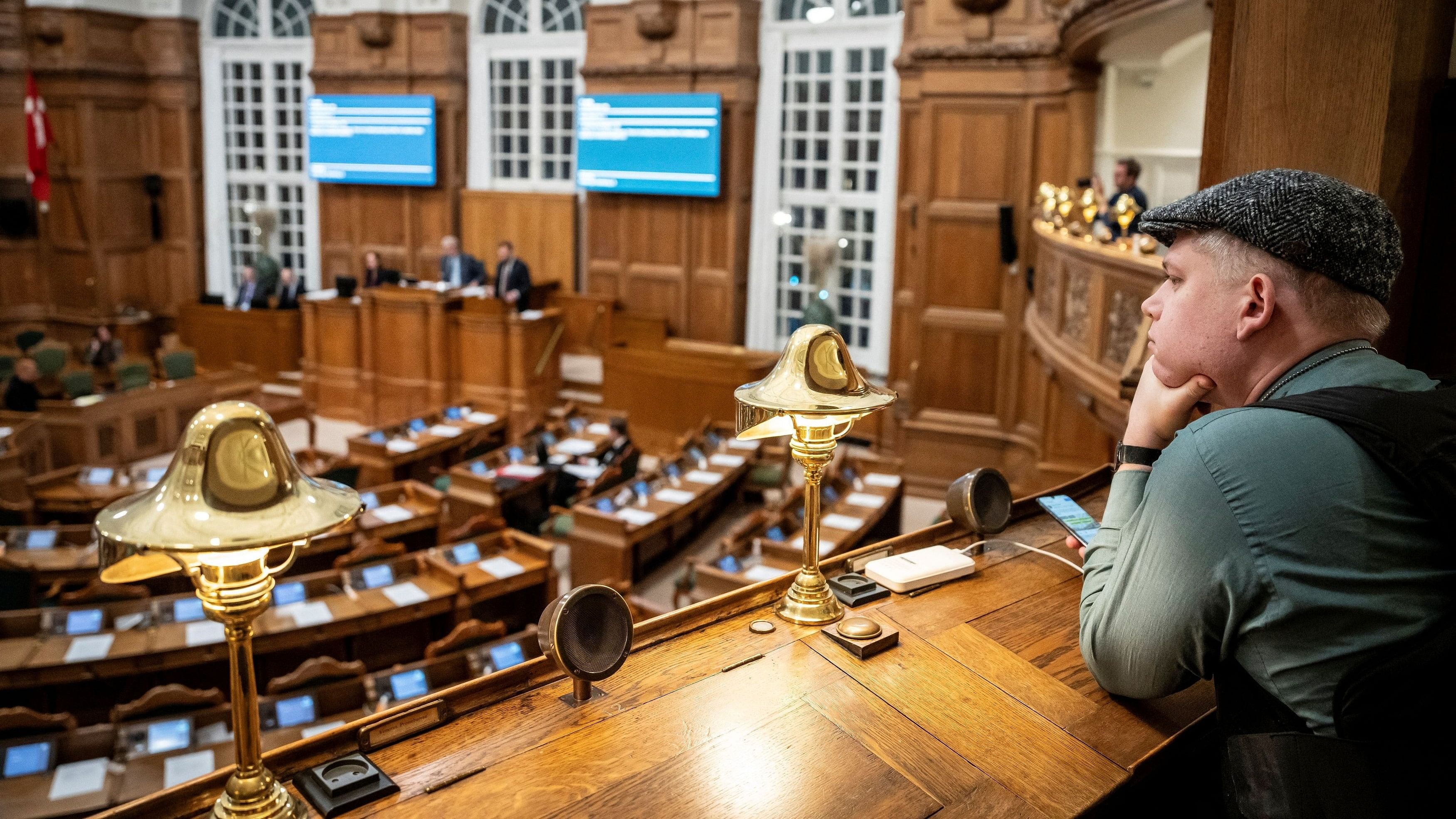 <div class="paragraphs"><p>Rasmus Paludan, leader of the right-wing political party Stram Kurs, listens from the press seats during a meeting in the Danish Parliament for the first reading of a proposed bill that would make it illegal to burn copies of the Koran in public places, at Christiansborg Castle in Copenhagen, Denmark.&nbsp;</p></div>