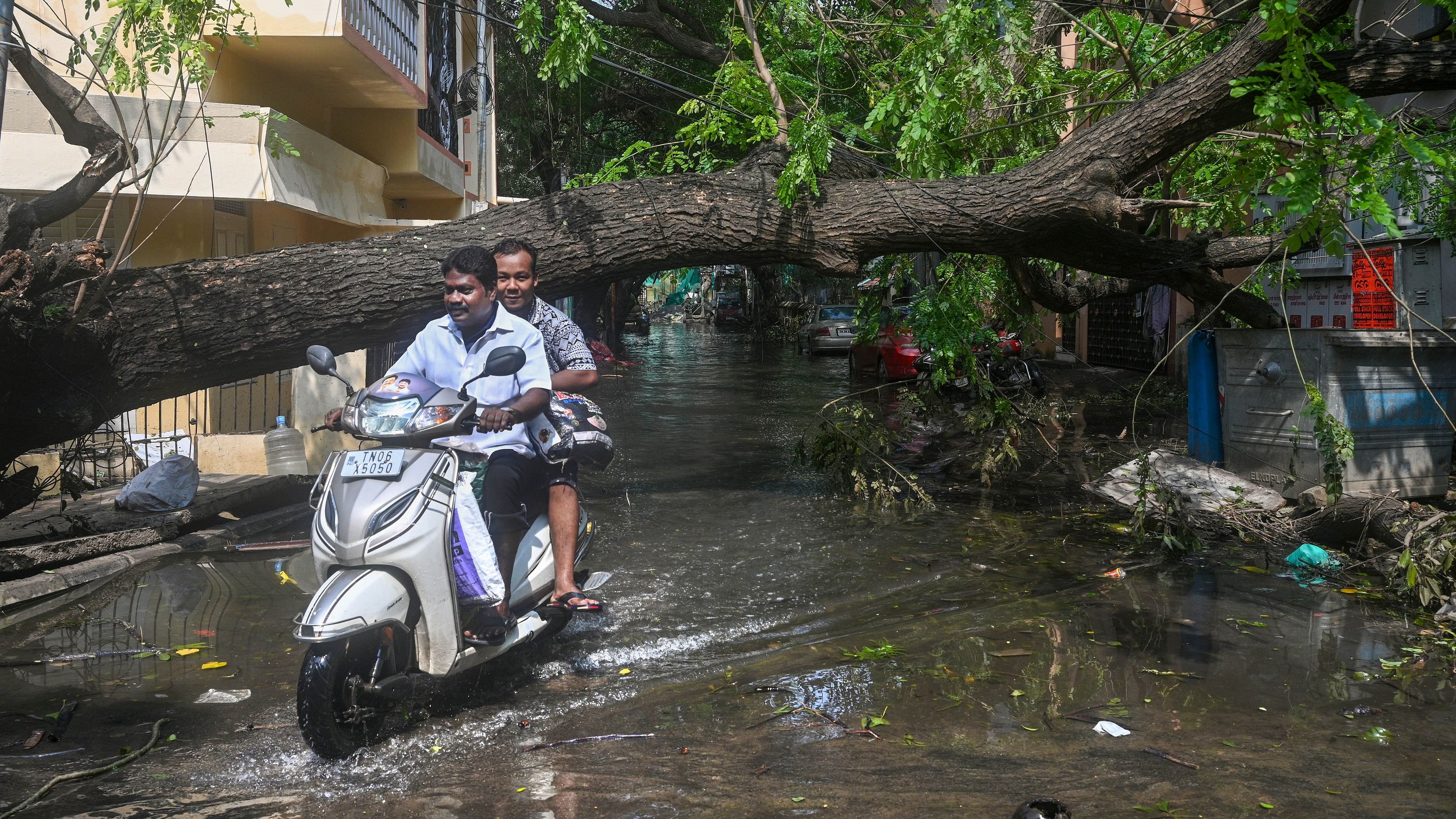 <div class="paragraphs"><p>Commuters on a flooded road after heavy rainfall owing to Cyclone Michaung, at Mylapore in Chennai district, Tamil Nadu, on Wednesday. </p></div>