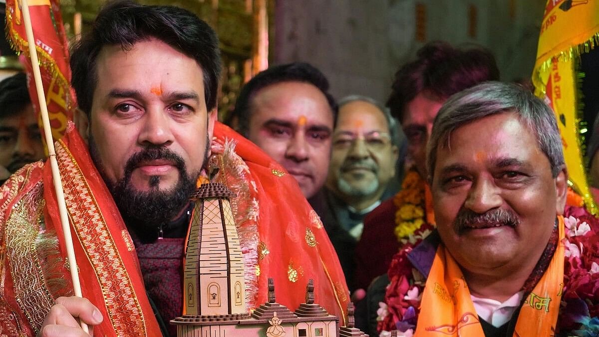 <div class="paragraphs"><p>Union Minister Anurag Singh Thakur with NDMC Vice Chairman Satish Upadhyay holds a model of the Shri Ramjanmbhoomi Mandir during a visit to the Hanuman Mandir, Connaught Place in New Delhi, Tuesday, Jan. 16, 2024.</p></div>