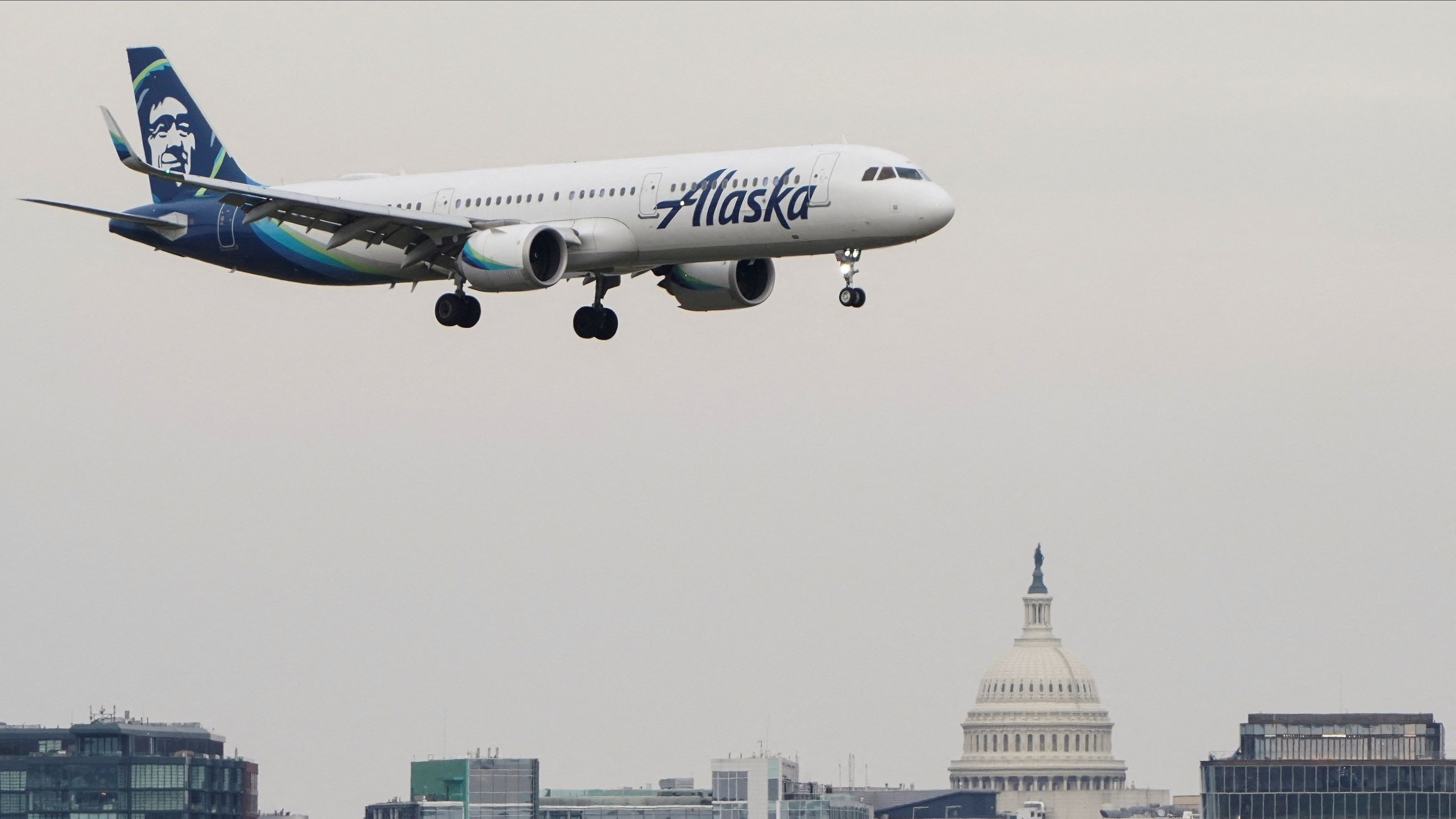 <div class="paragraphs"><p>An Alaska Airlines aircraft flies past the US Capitol before landing at Reagan National Airport in Arlington, Virginia, US, January 24, 2022.   </p></div>