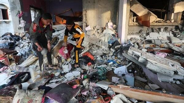 <div class="paragraphs"><p>Palestinian boys inspect inside a house damaged in an Israeli strike, amid the ongoing conflict between Israel and the Palestinian Islamist group Hamas, in Rafah, in the southern Gaza Strip.</p></div>