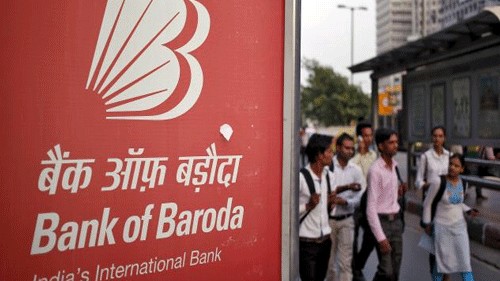 <div class="paragraphs"><p>Commuters walk past an advertisement of Bank of Baroda.&nbsp;</p></div>