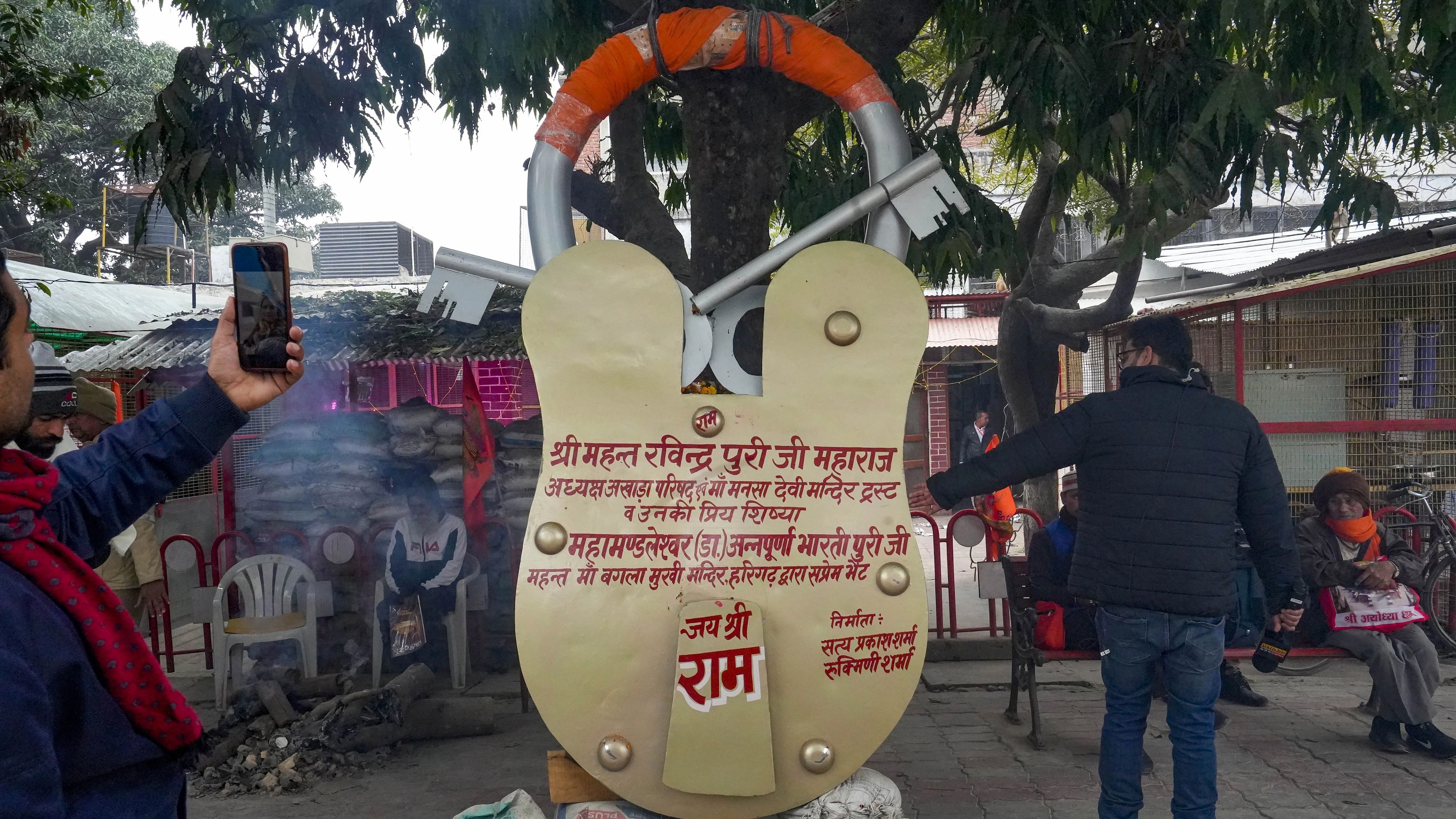 <div class="paragraphs"><p>People click pictures with the lock, ahead of the consecration ceremony of Ram Mandir, in Ayodhya, Saturday, Jan. 20, 2024. </p></div>