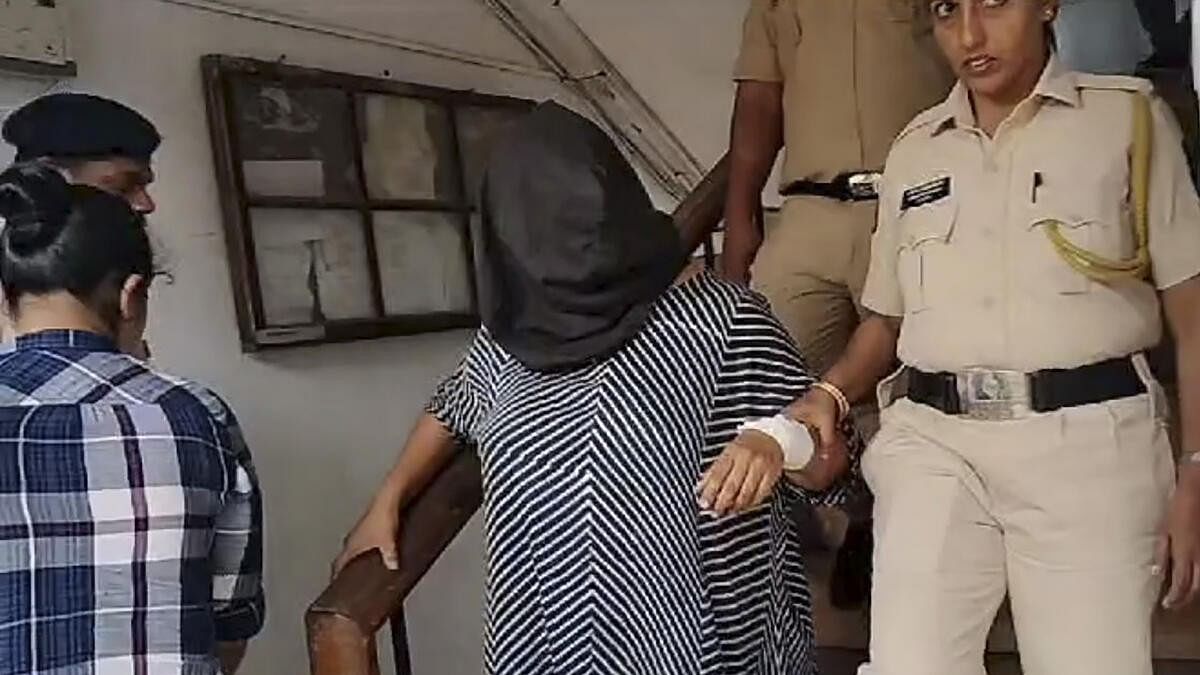 <div class="paragraphs"><p>Suchana Seth with police.</p></div>