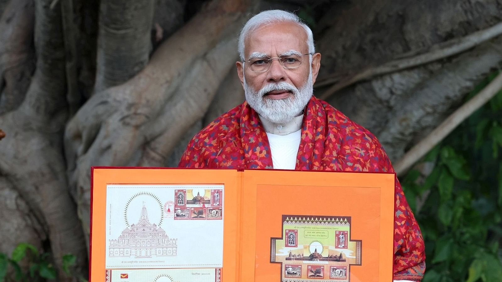 <div class="paragraphs"><p>PM Narendra Modi with a book of stamps.</p></div>