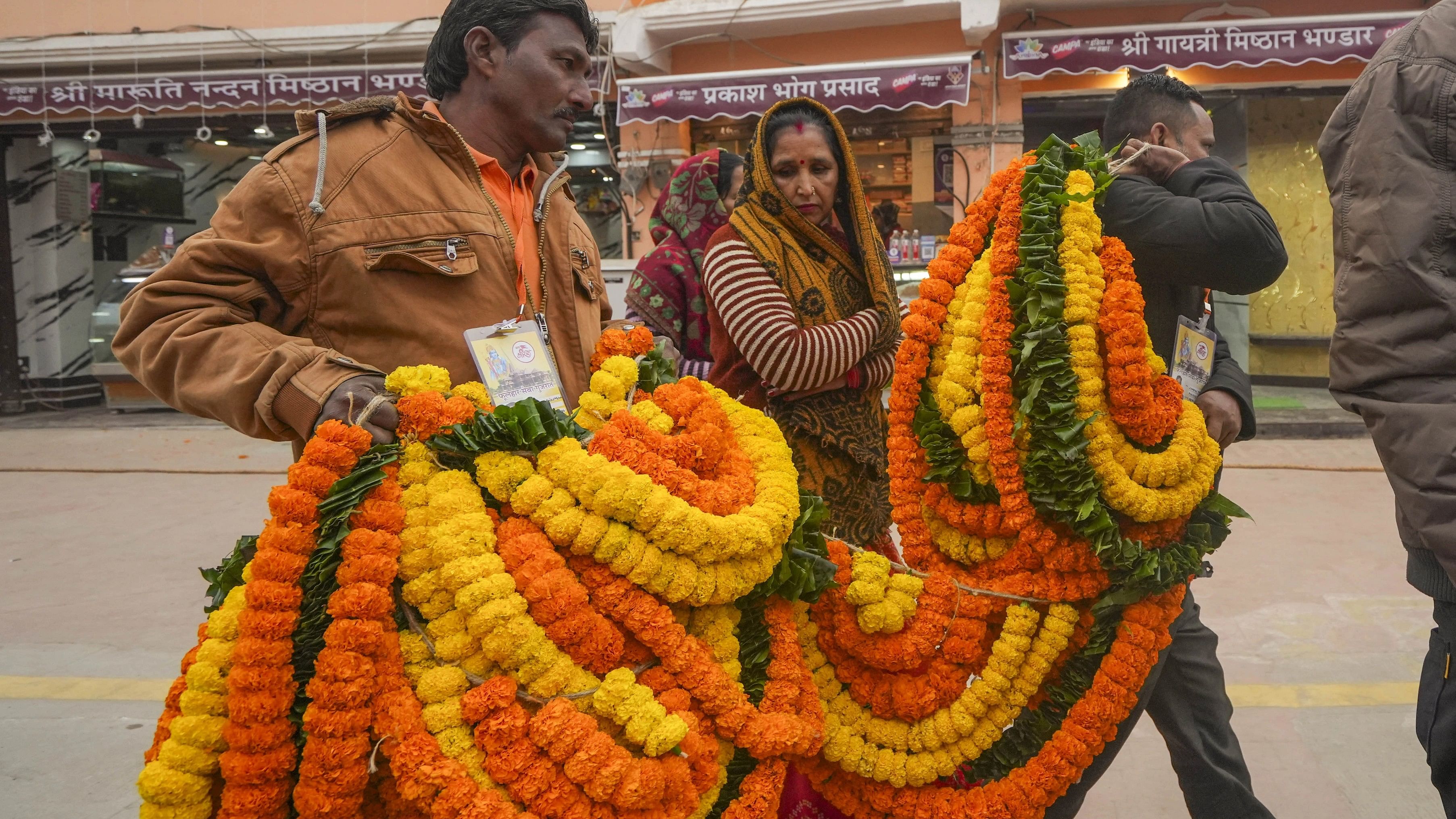 <div class="paragraphs"><p>People carry flower garlands ahead of the 'Pran Pratishtha' ceremony of Ram Temple, in Ayodhya on Saturday, Jan. 20, 2024.</p></div>