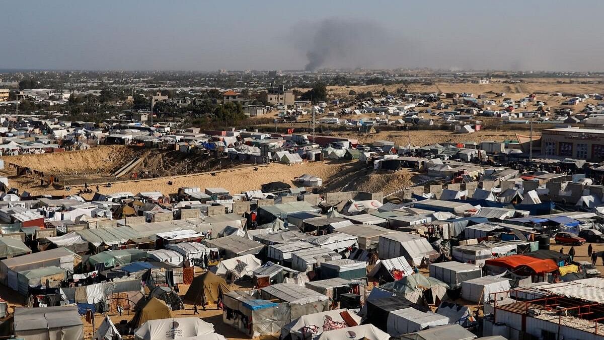 <div class="paragraphs"><p>view of a tent camp housing displaced Palestinians, as smoke rises in the distance due to an Israeli ground operation in Khan Younis.</p></div>