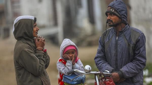 <div class="paragraphs"><p>People wearing warm clothes during a cold winter morning, in Jammu, Monday, January 8, 2024.</p></div>