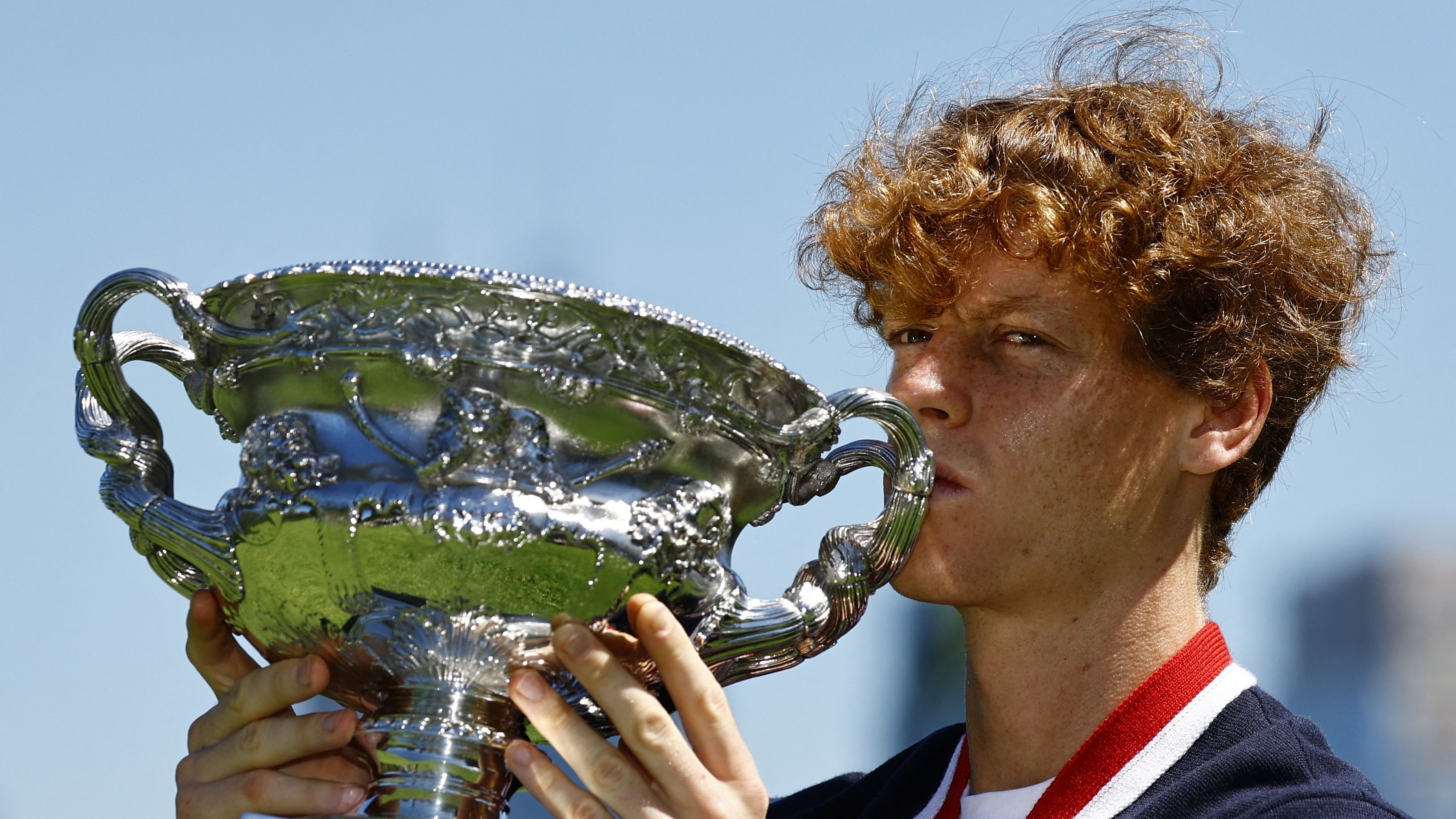 <div class="paragraphs"><p>Jannik Sinner poses with the Australian Open trophy.</p></div>