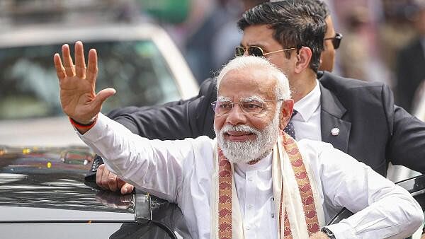 <div class="paragraphs"><p>Prime Minister Narendra Modi waves at people gathered for his welcome upon his arrival at Thriprayar, in Thrissur district, Wednesday, January 17, 2024.</p></div>