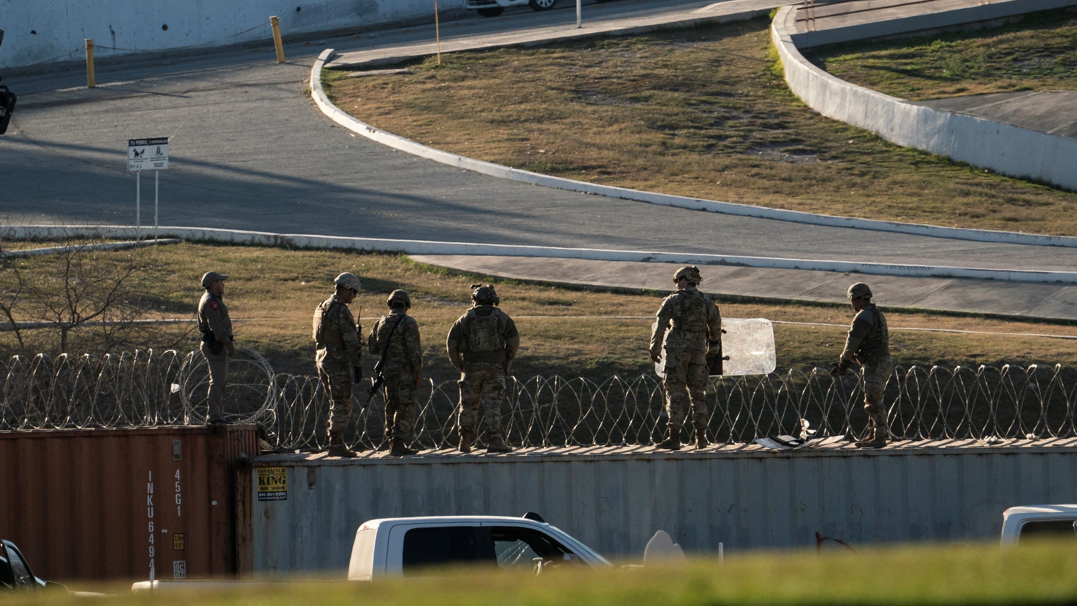<div class="paragraphs"><p>US National Guard soldiers stand on shipping containers which are used as border fences on the bank of the Rio Grande river in Eagle Pass, Texas, US.</p></div>