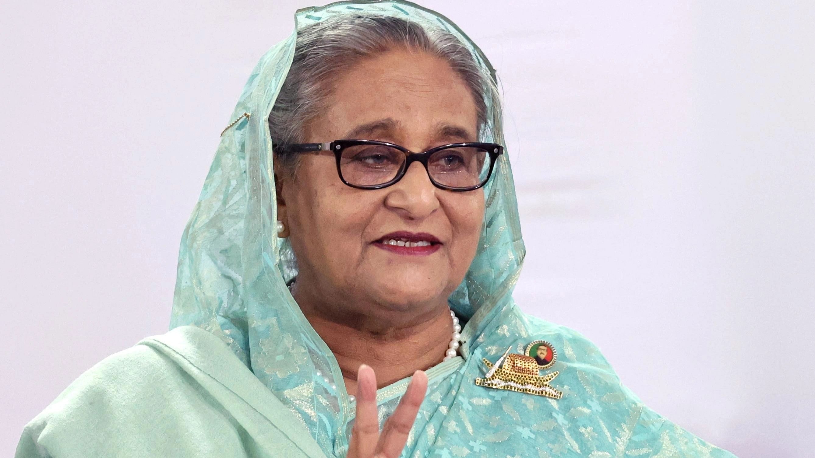 <div class="paragraphs"><p>Sheikh Hasina, Prime Minister of Bangladesh and Chairperson of Bangladesh Awami League, shows a victory sign while speaking to the press after casting her vote at the Dhaka City College center during the 12th general election in Dhaka, Bangladesh, January 7, 2024.  </p></div>