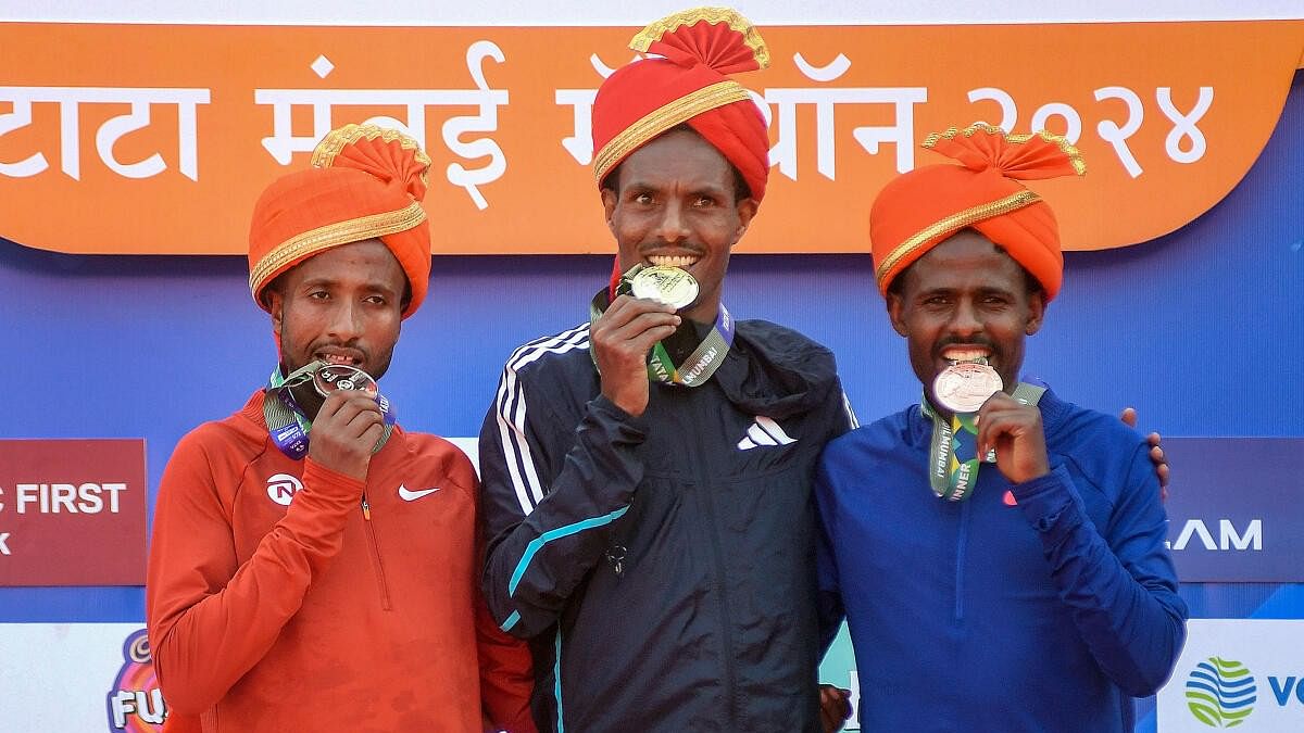 <div class="paragraphs"><p>Ethiopia's athletes; Gold medallist Hayle Lemi Berhanu (centre), silver medallist Haymanot Alew (left) and bronze medallist Mitku Tafa pose for photos during the presentation ceremony of International Elite Men's category at the TATA Mumbai Marathon 2024, in Mumbai, Sunday, Jan. 21, 2024. </p></div>