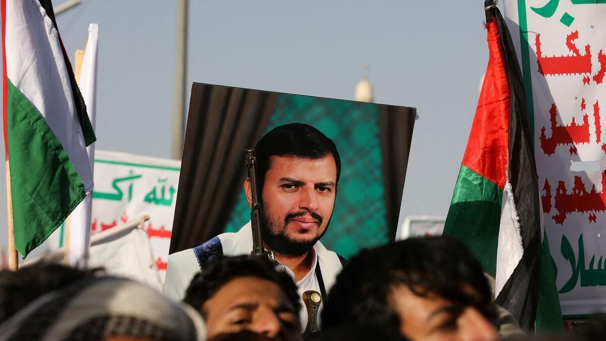 <div class="paragraphs"><p>A person holds a placard with a picture of Yemen's Houthi movement leader Abdul-Malik al-Houthi, as supporters of the Houthi movement rally to denounce air strikes launched by the U.S. and Britain on Houthi targets, in Sanaa, Yemen January 12, 2024.</p></div>